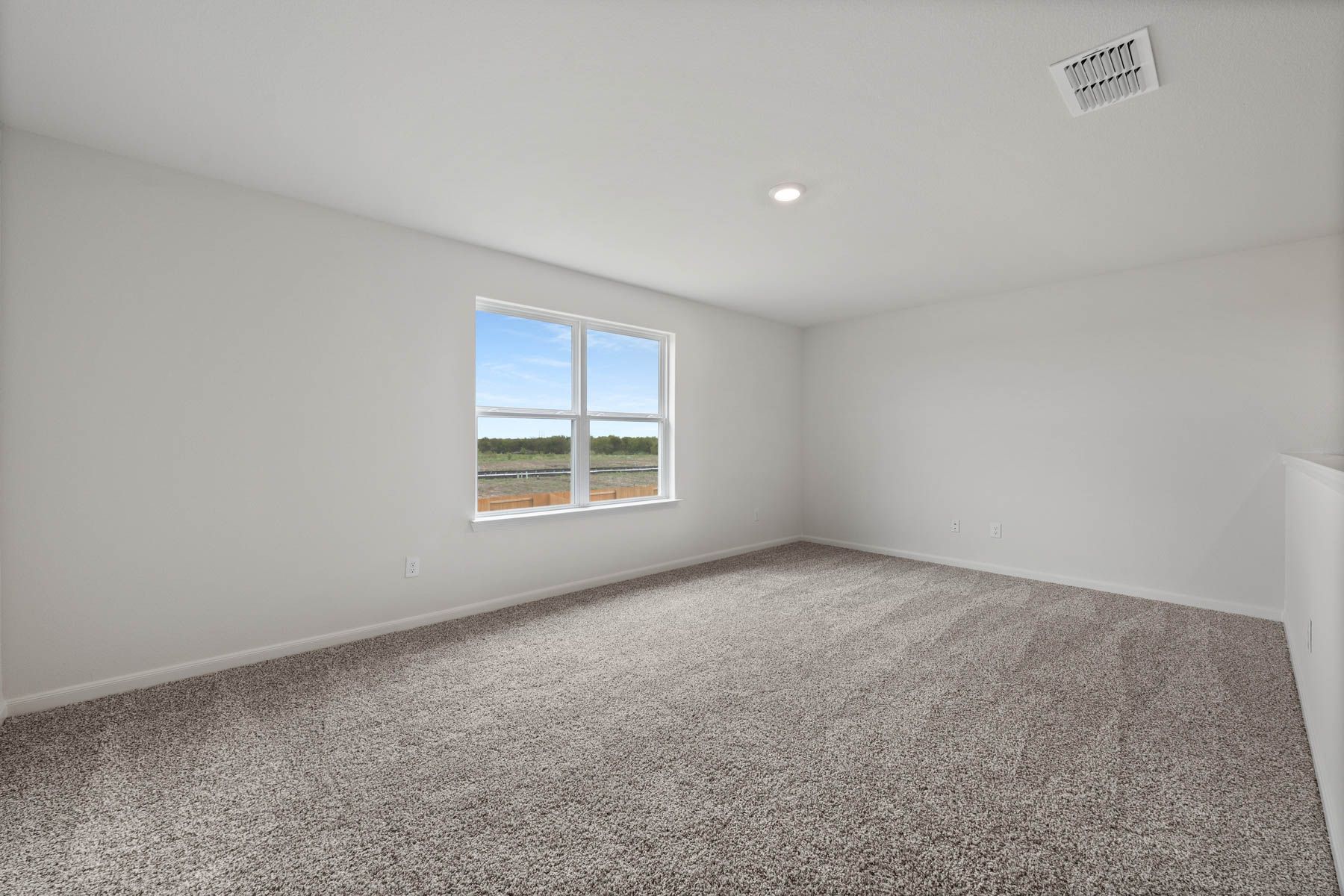 The loft in the Driftwood has a large window and plenty of space for furniture.