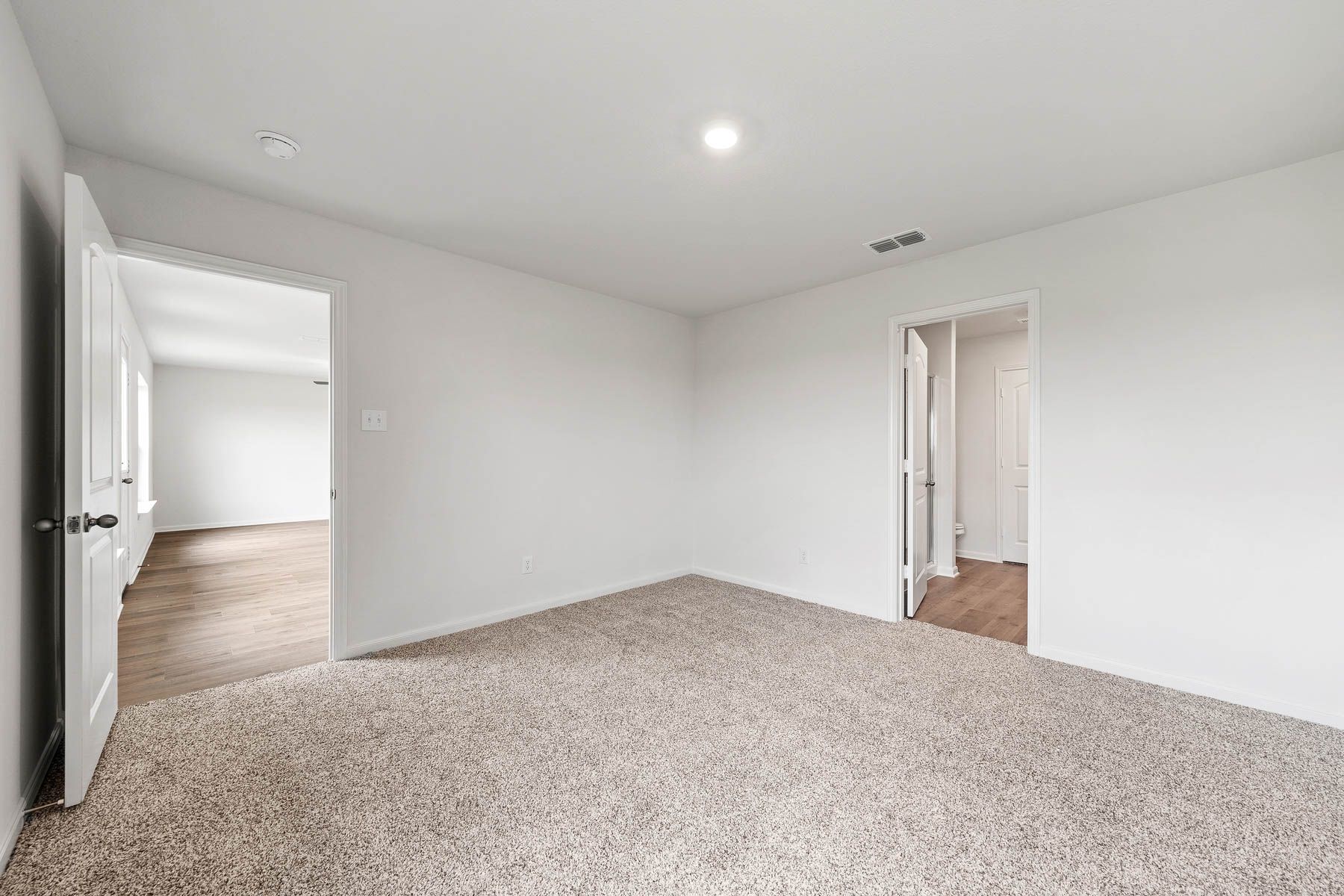 The master suite includes a large bedroom, private bathroom and walk-in closet.
