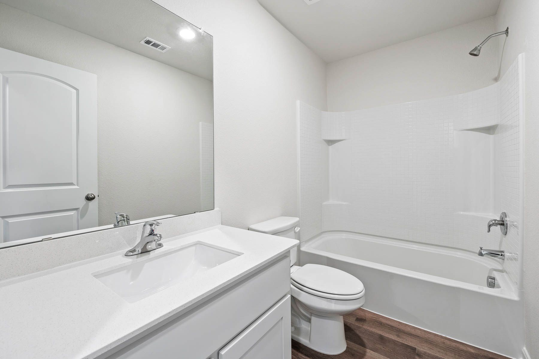 The secondary bathroom has plenty of counterspace and a large shower-tub combo.