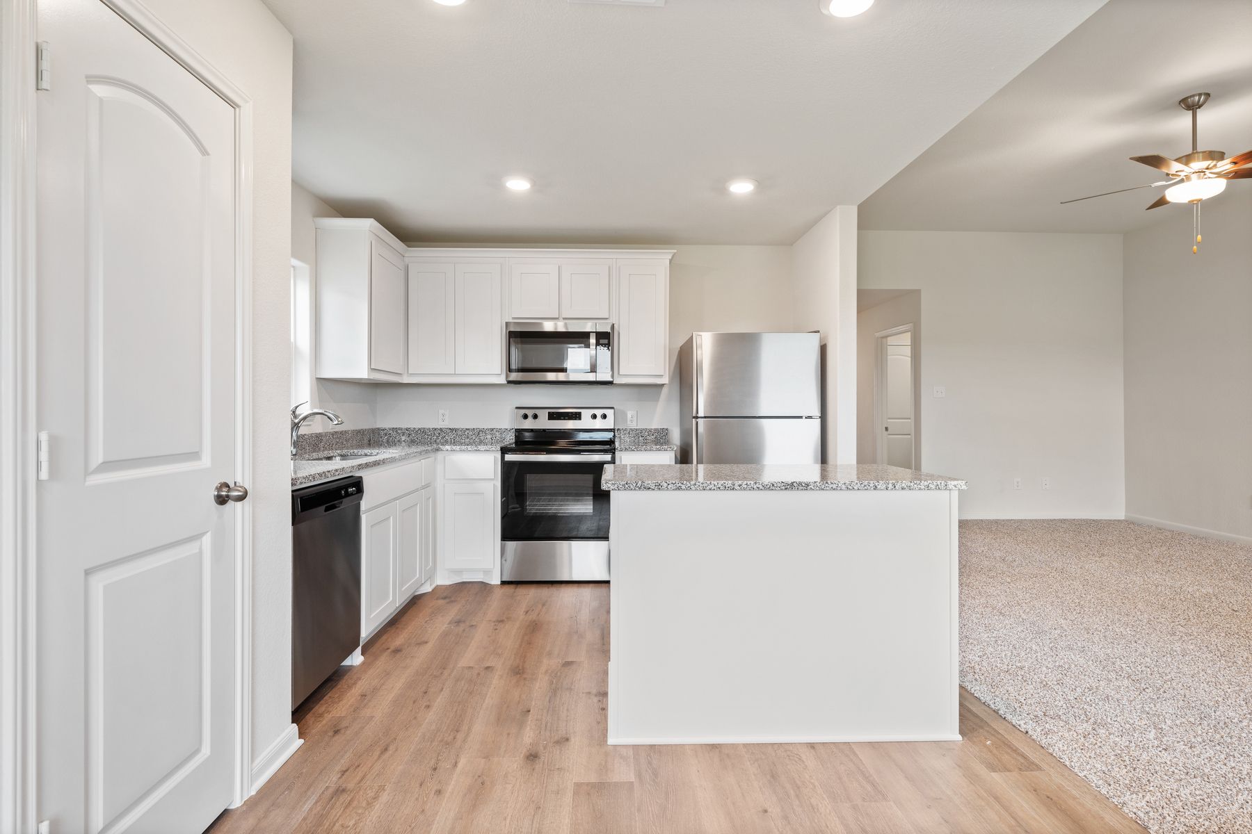 The kitchen of the Blanco has beautiful white wood cabinets.