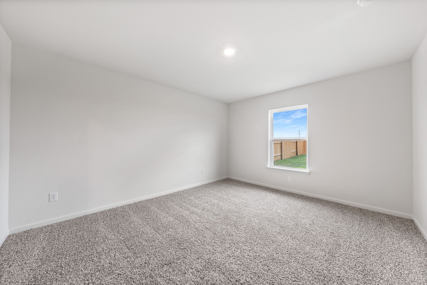 The master bedroom of the Blanco has a window that lets in great natural light and back yard views.