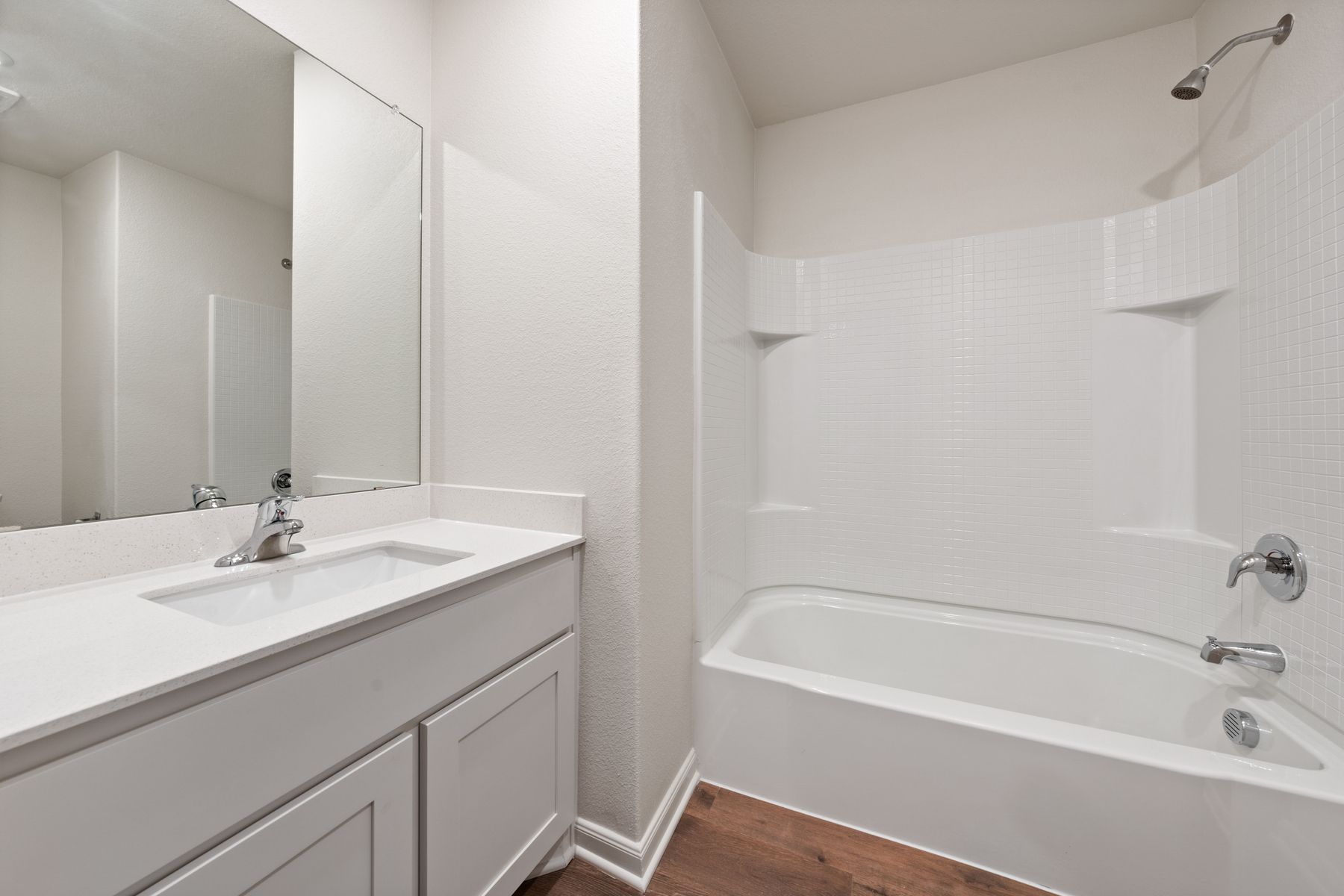 The secondary bathroom of the Blanco has a plenty of counterspace and a shower-tub combo.