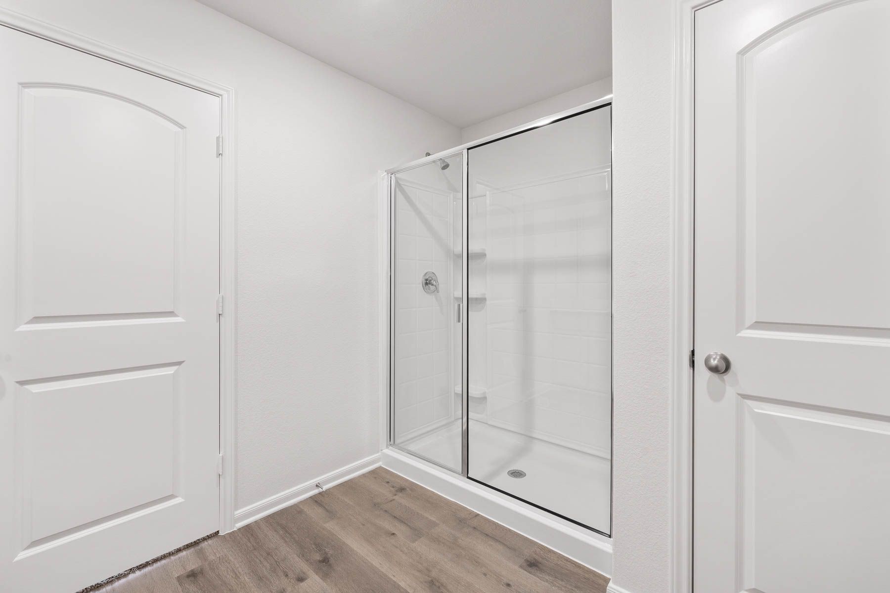 The master bathroom has a large walk-in, glass shower.