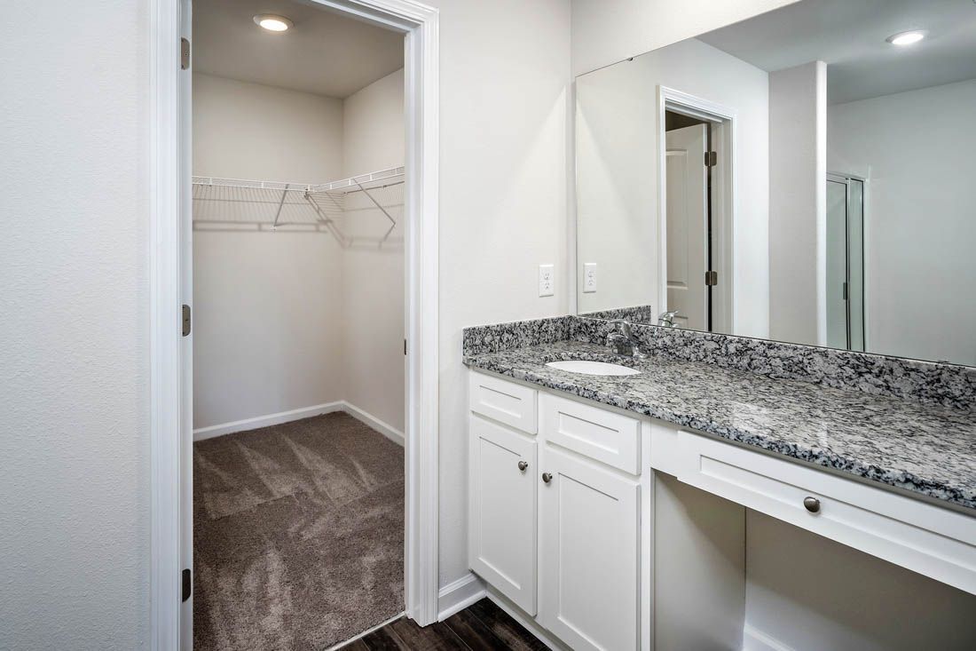 Master bath has makeup vanity and an attached walk-in closet