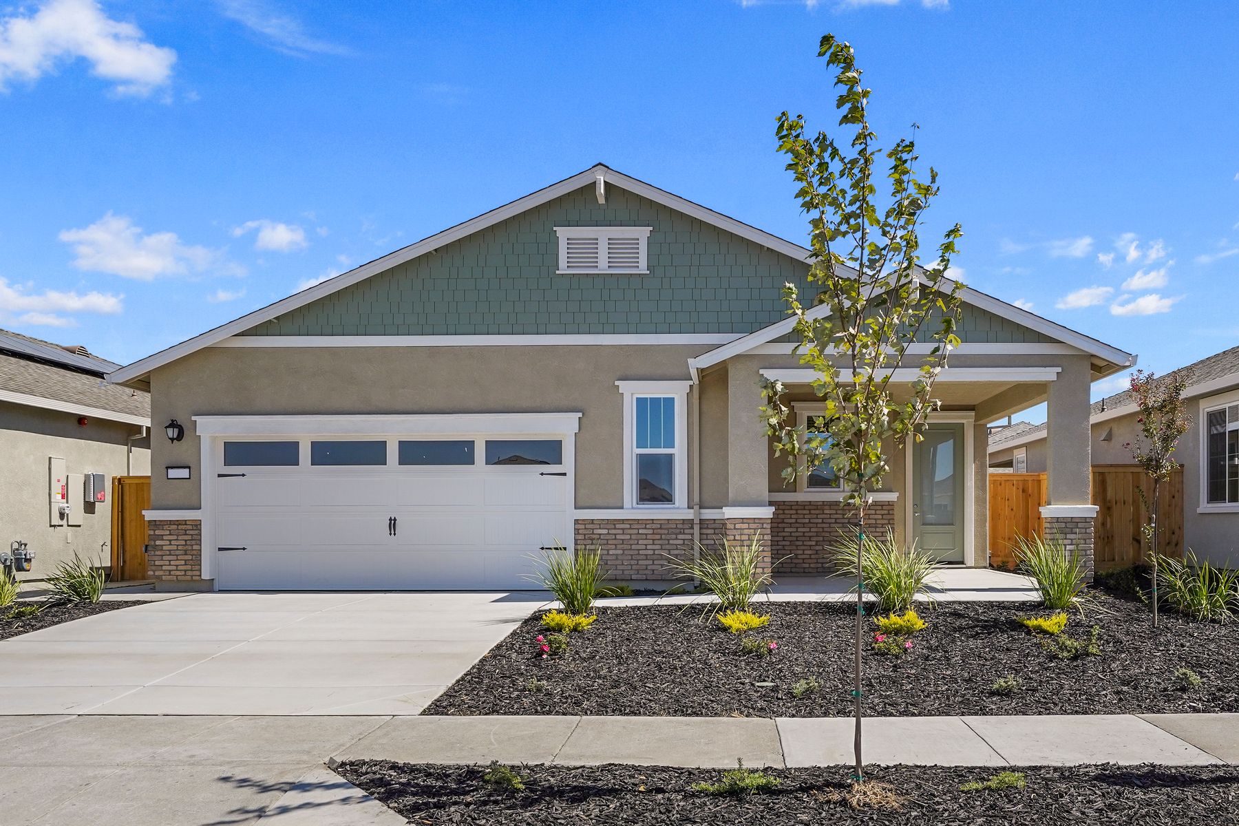 This home has a 2-car garage with a mix of stone and stucco exterior features.
