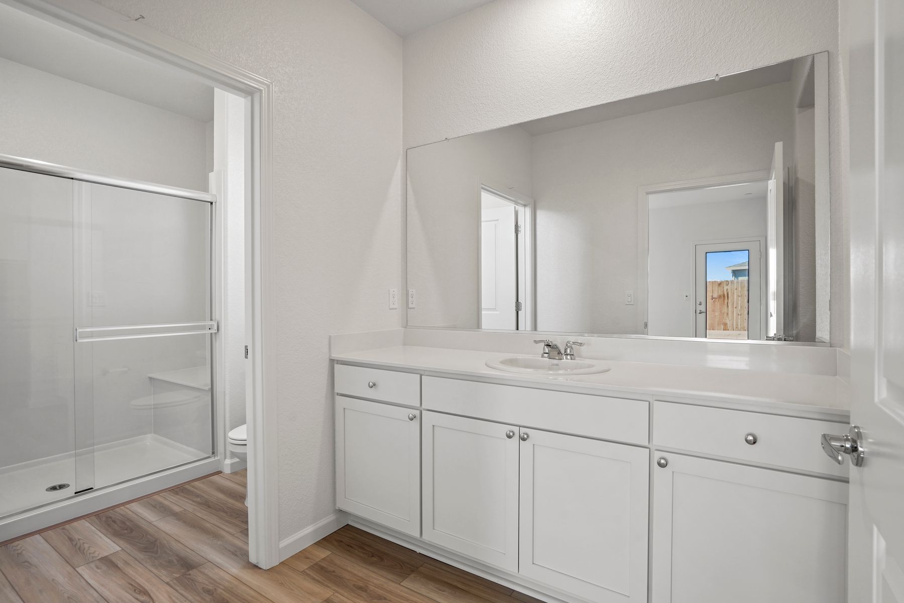 The bathroom is spacious with bright lighting.