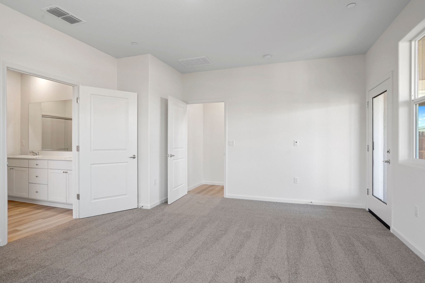 The master bedroom is a spacious and well lit room