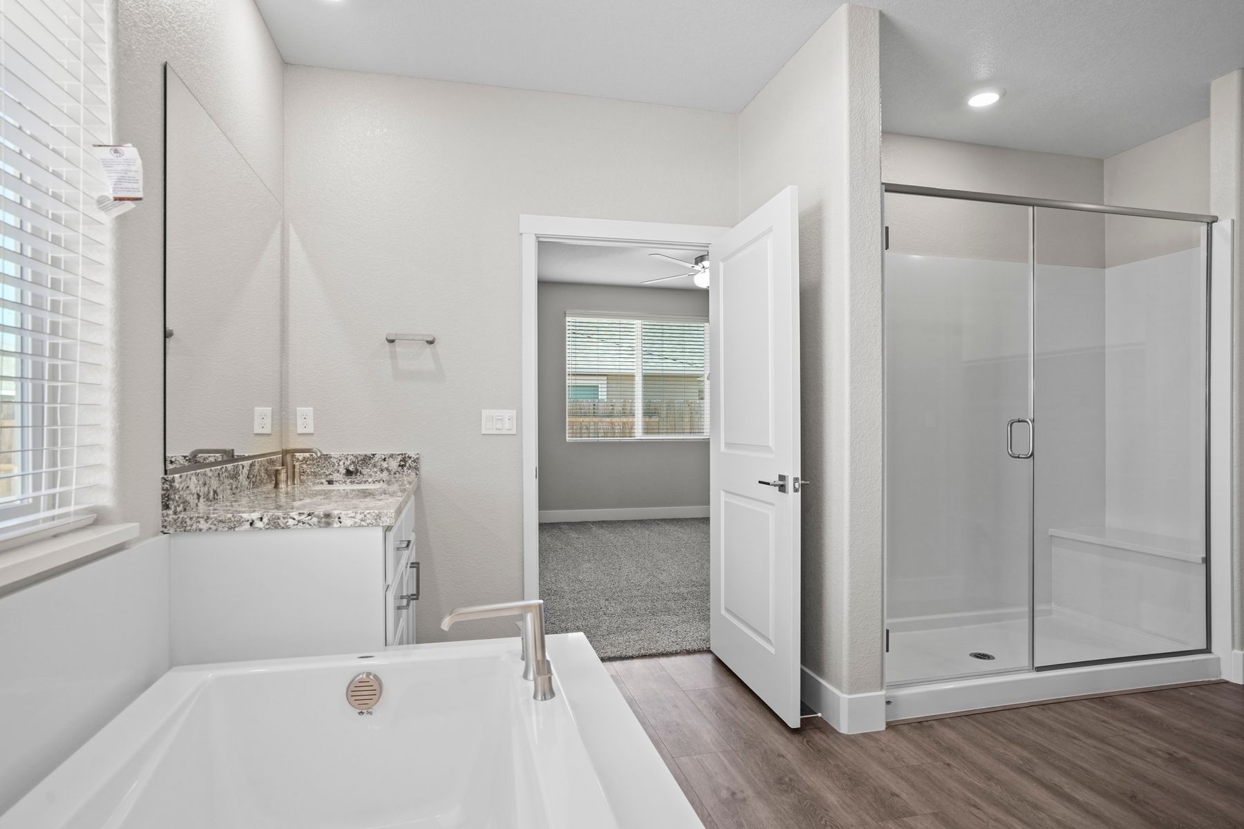 The master bath has a deep bath, walk-in shower, and spacious closet space