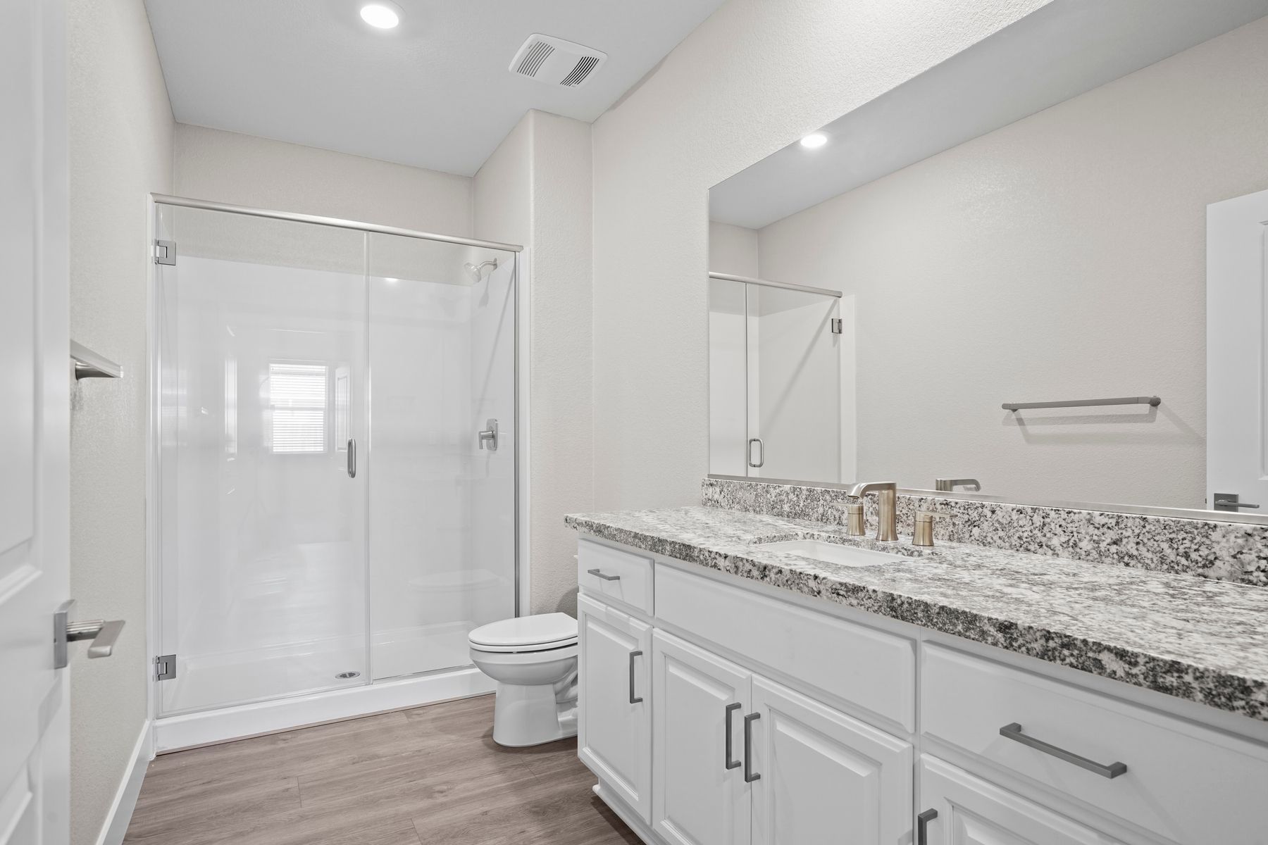 The bathroom has ample counterspace and beautiful granite countertops