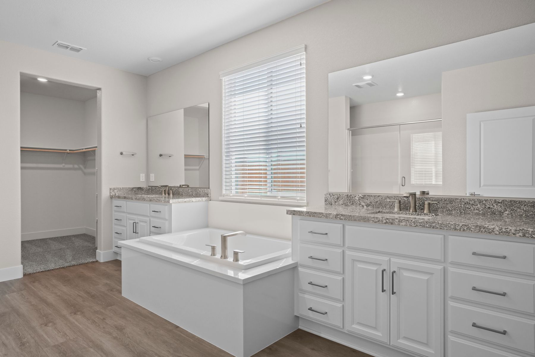 This bathroom has a deep bathtub along with ample countertop space