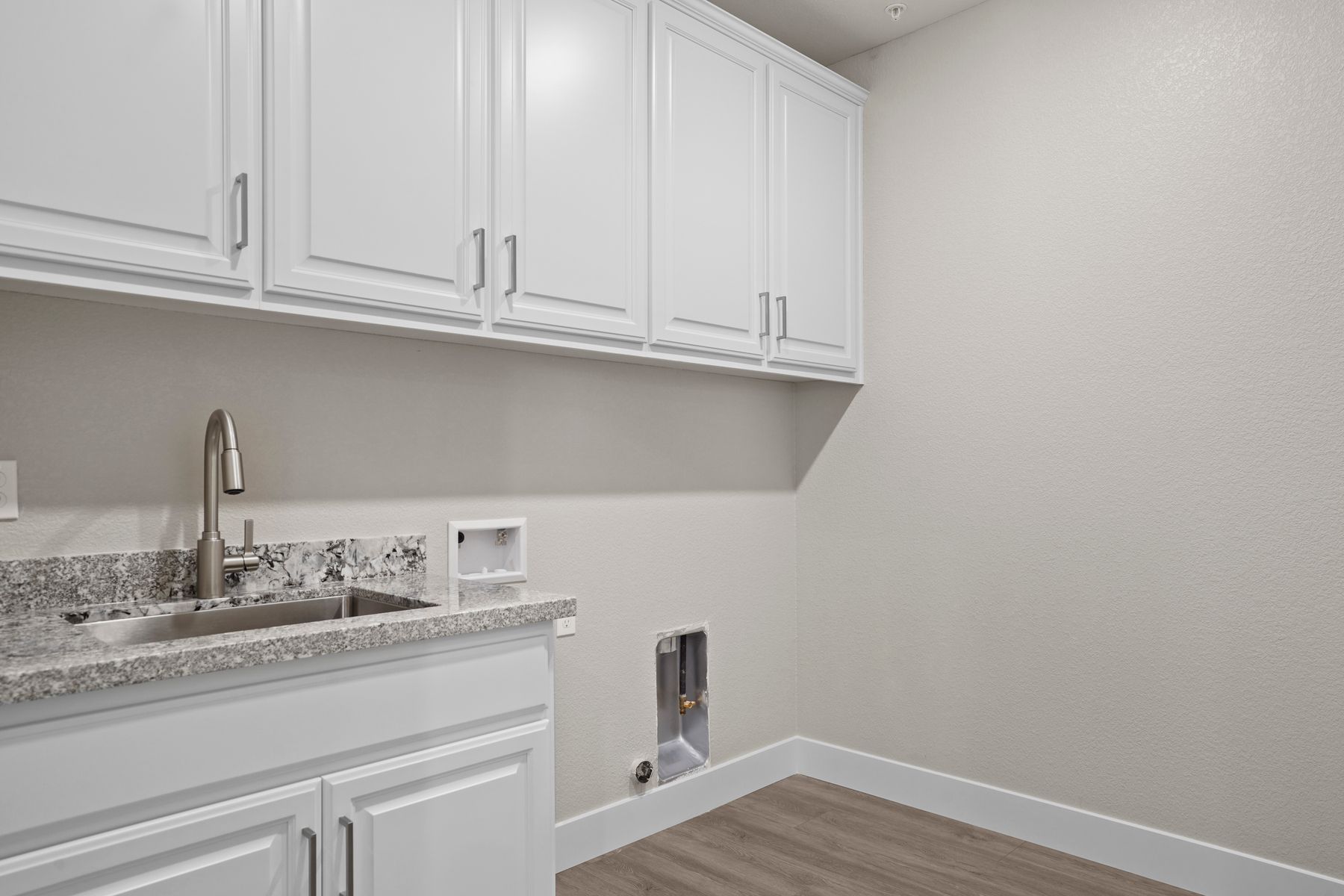 This spacious room is built to support a washer and dryer