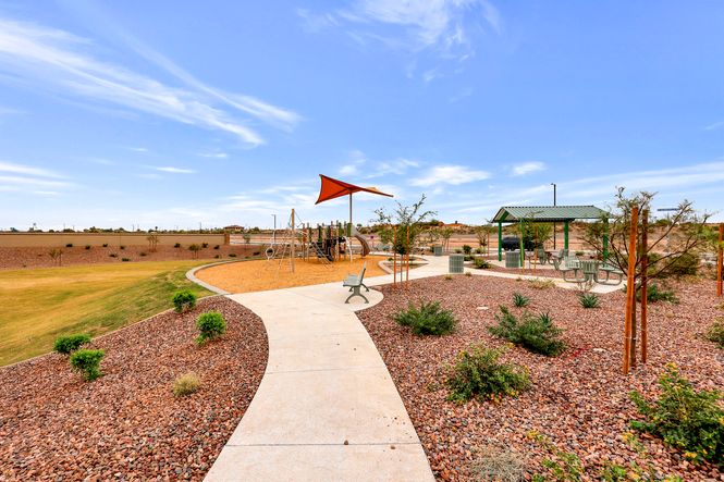 This park offers green space, a playground, a shade ramada, and park benches.