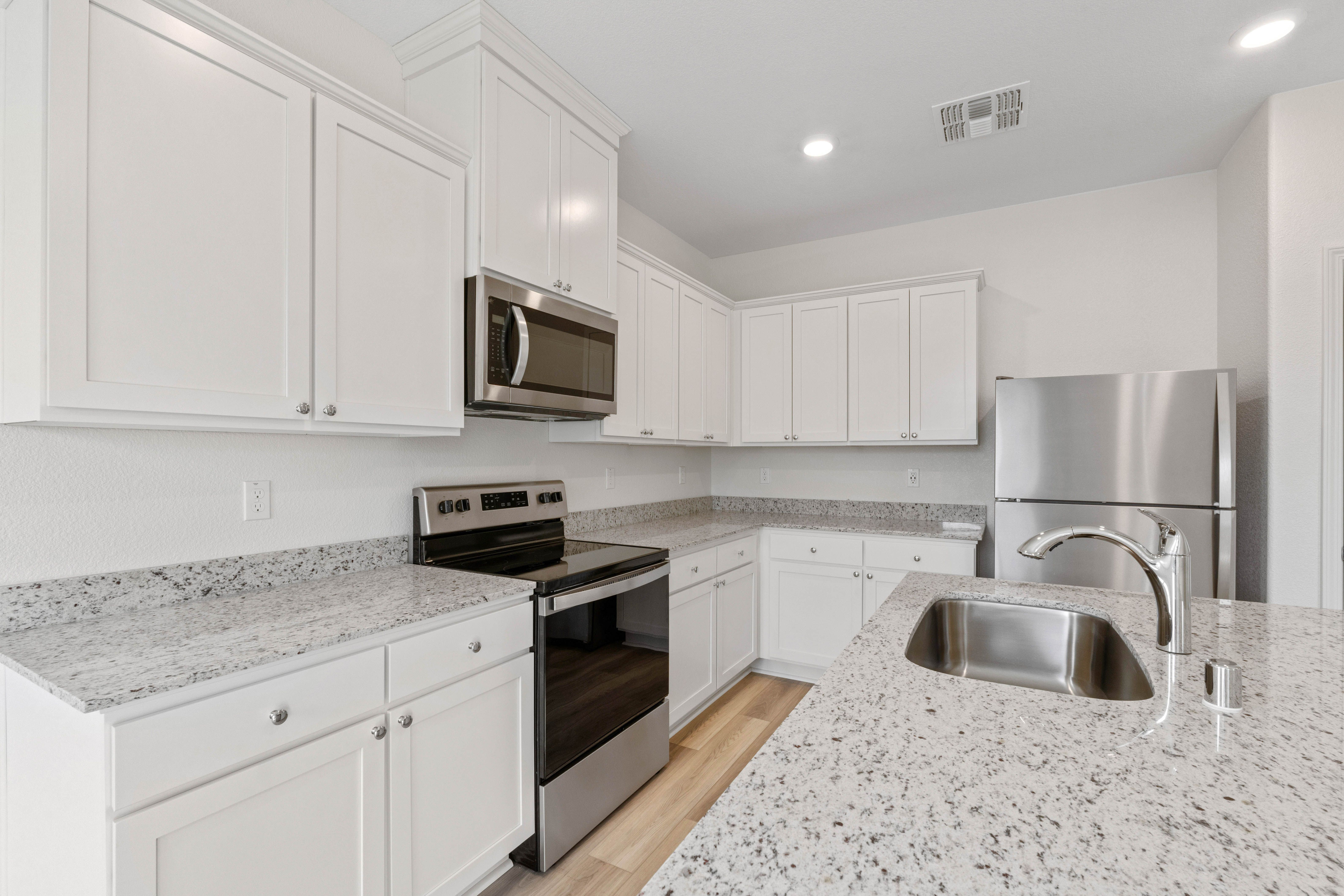 This kitchen has a full suite of stainless steel appliances.