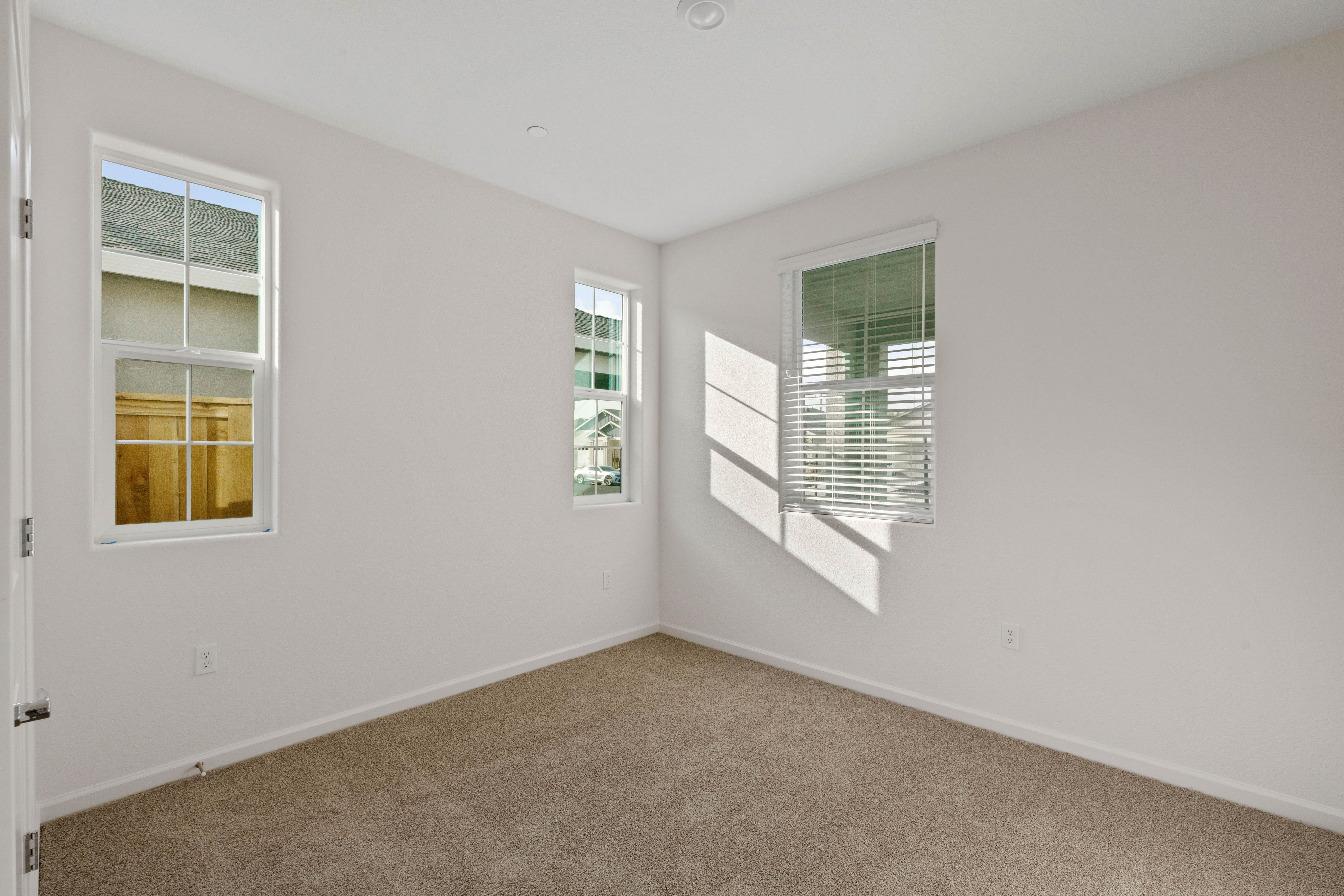 Windows let in plenty of light to this second bedroom