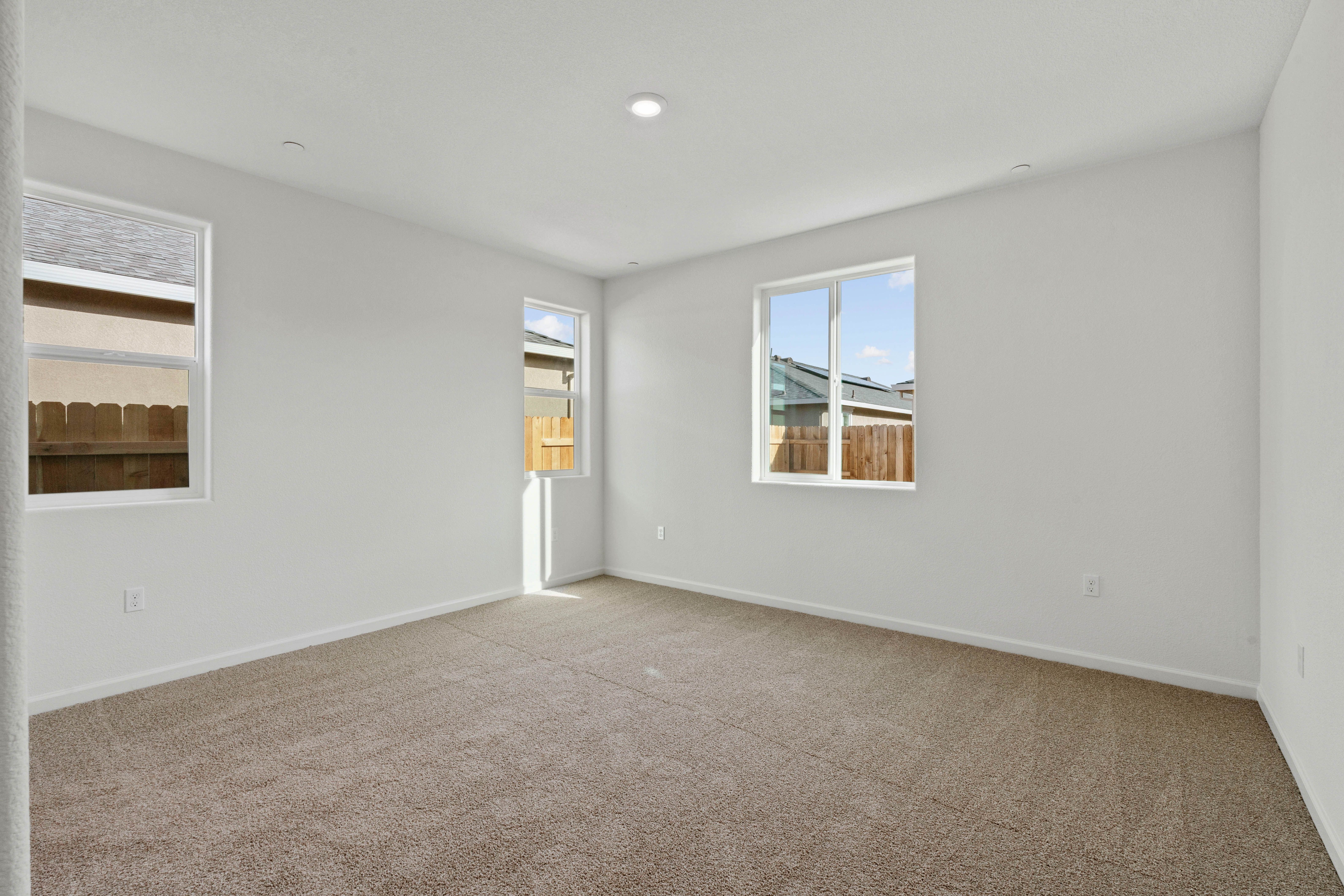 The master suite of this home has plenty of space for your king-sized furniture.