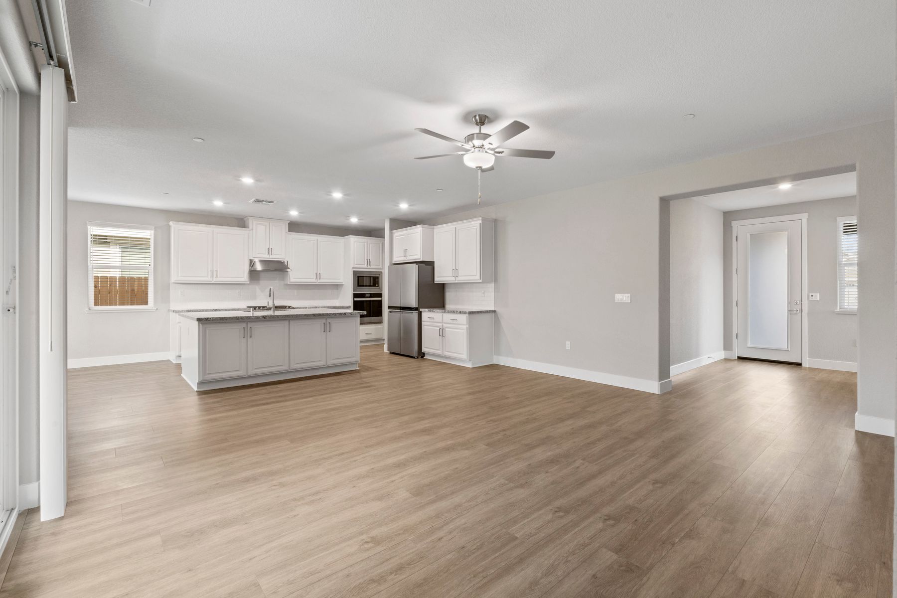 The kitchen features bright white cabinetry.