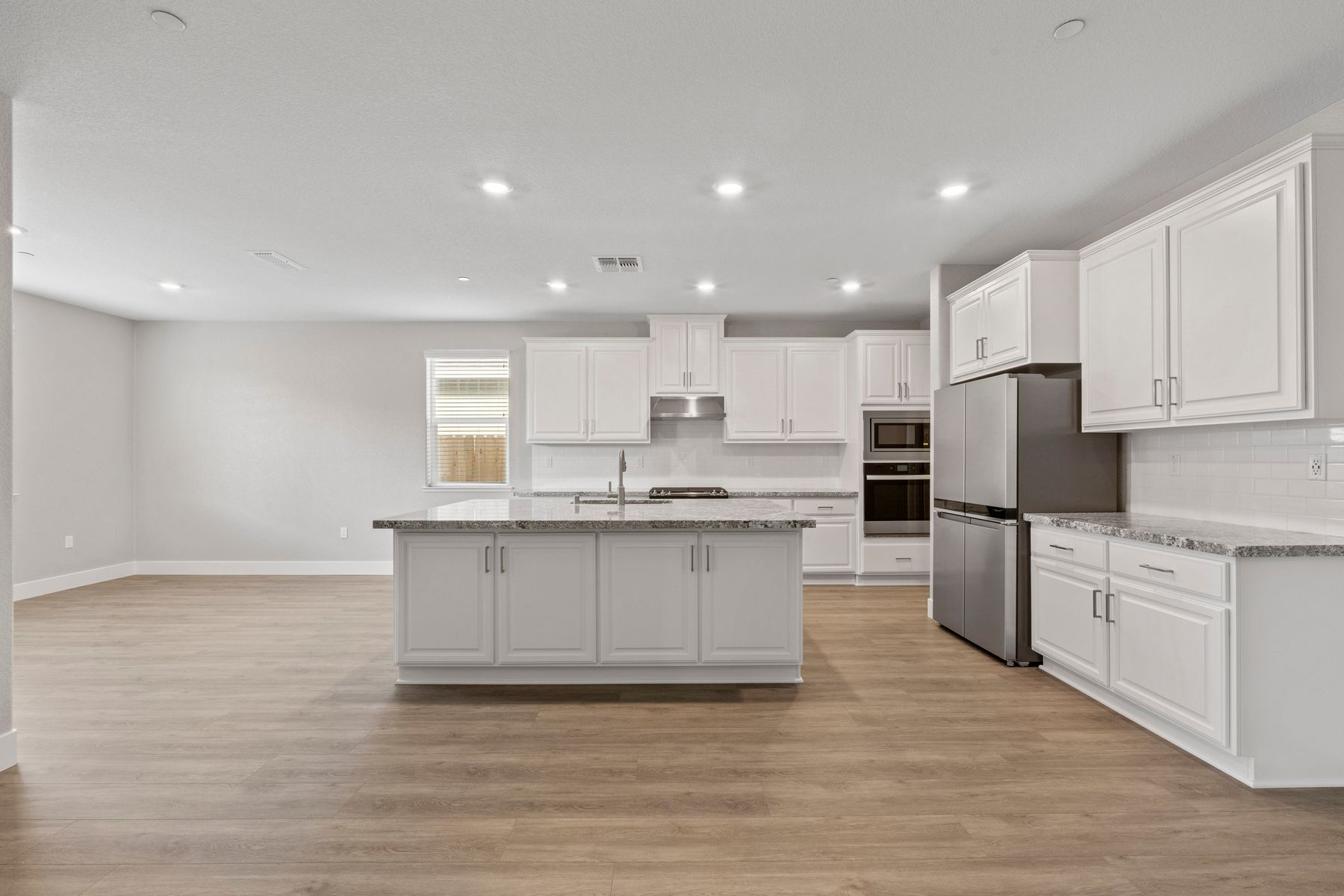 Enjoy stunning granite countertops and a bright white, spacious kitchen.