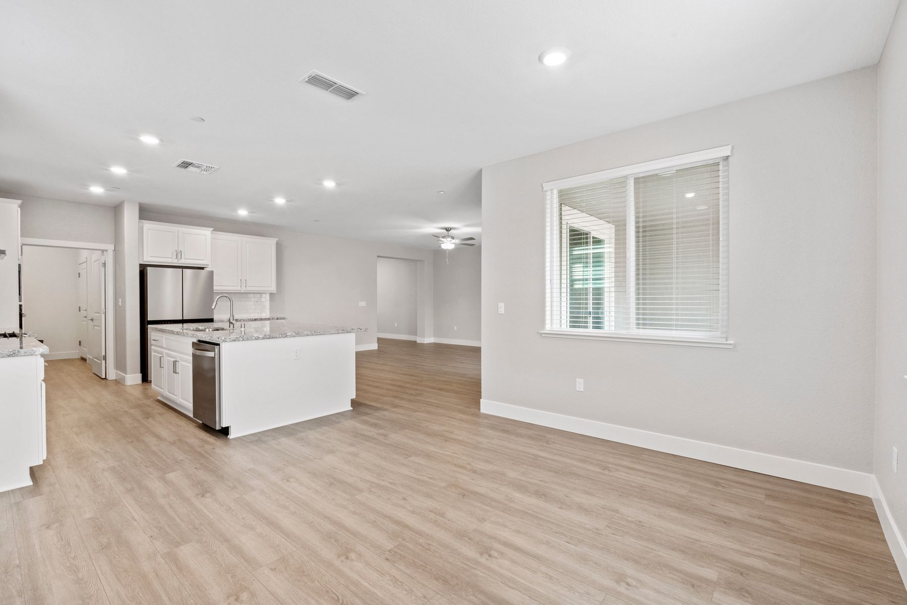 The kitchen, dining room, and living room let in beautiful natural lighting.
