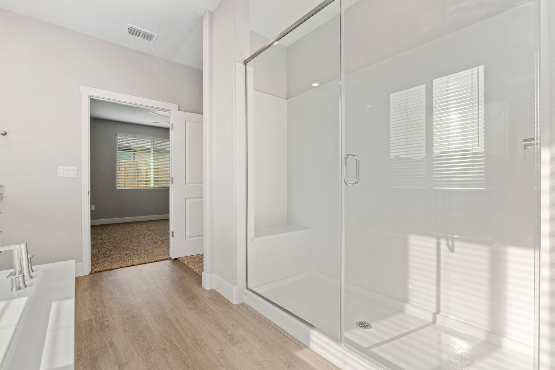 The master bath has a spacious, glass-enclosed shower.