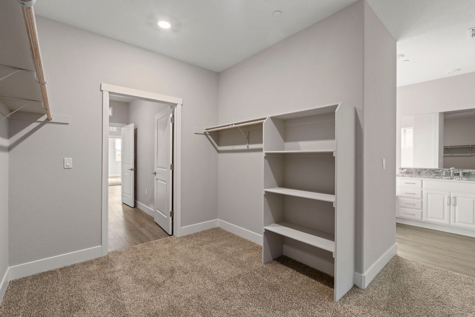 The walk-in closet features plenty of cabinet space.