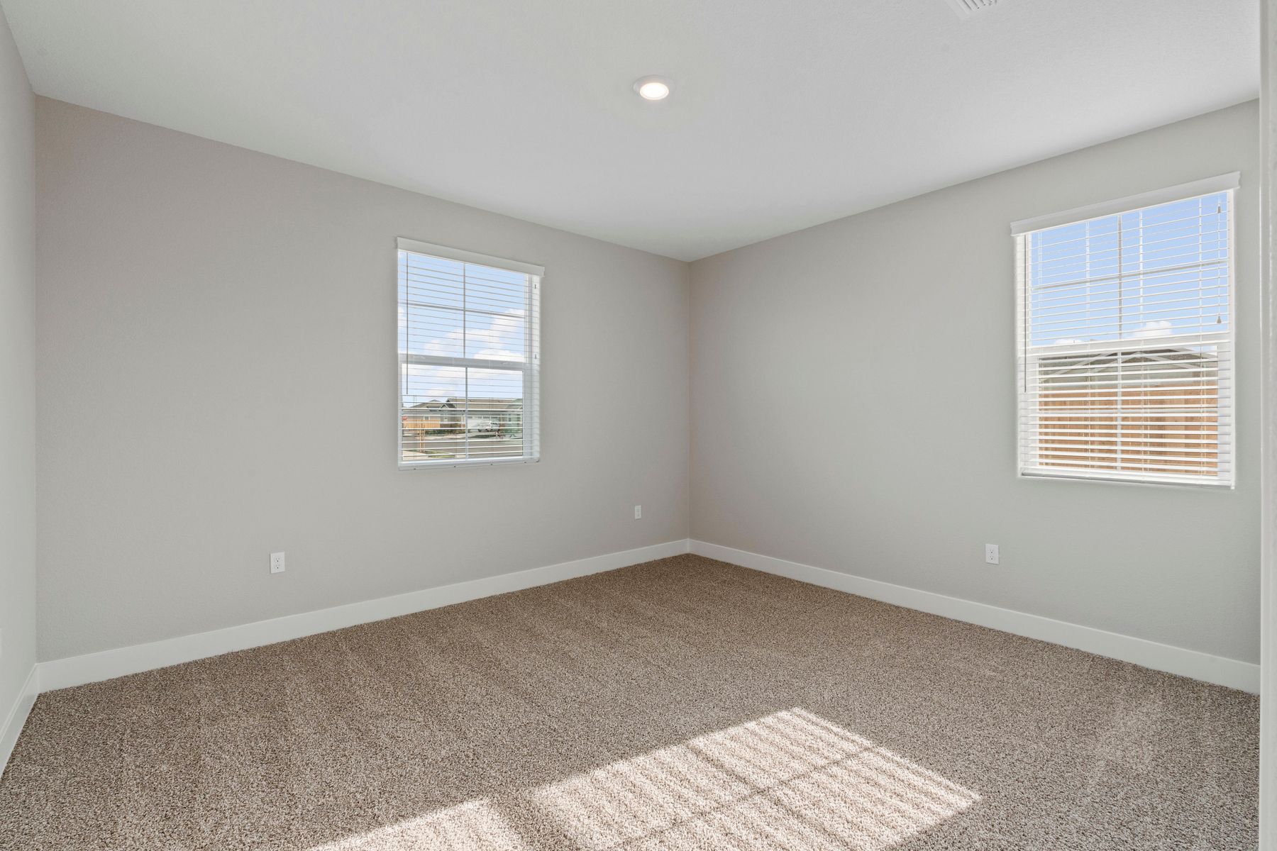 Windows let in plenty of light in the secondary bedroom.