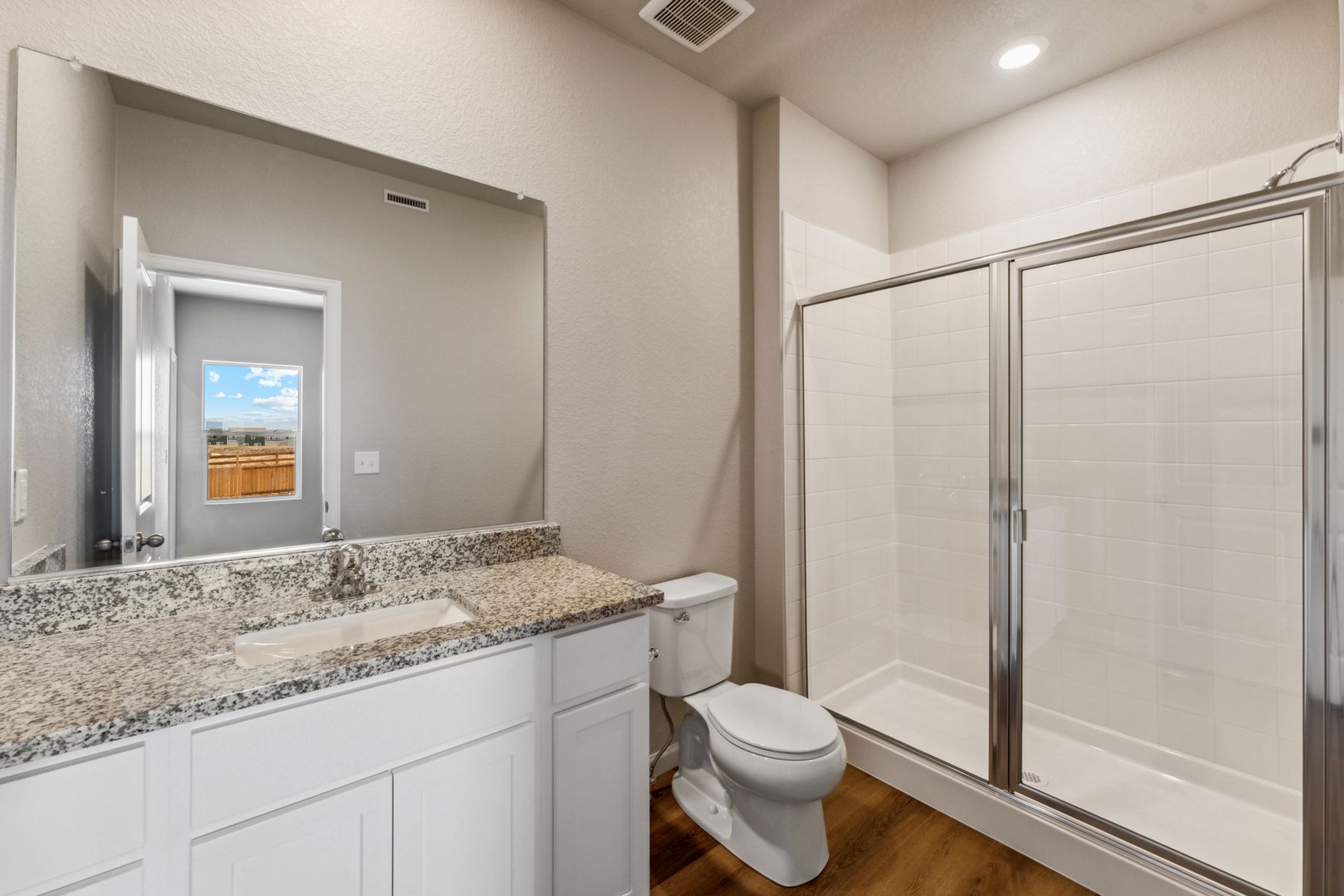 The master bathroom has a step in shower. 