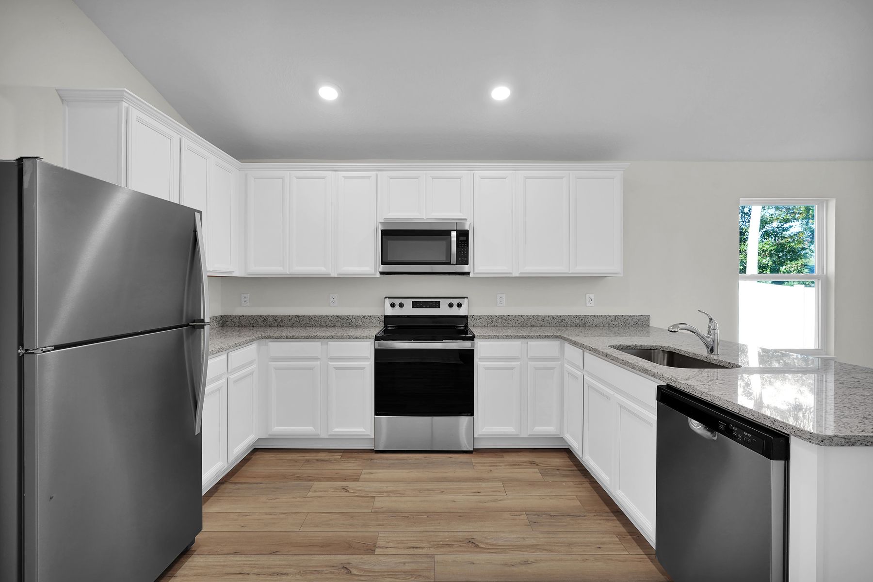 Enjoy stunning granite countertops and designer cabinetry in this kitchen.