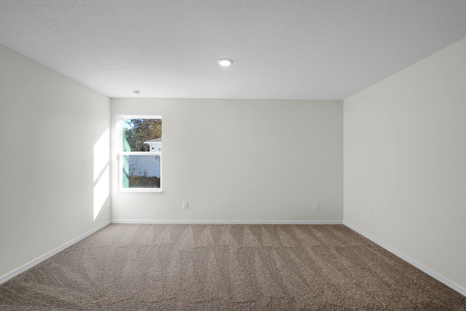 The master suite of this home has plenty of space for your king-sized furniture.