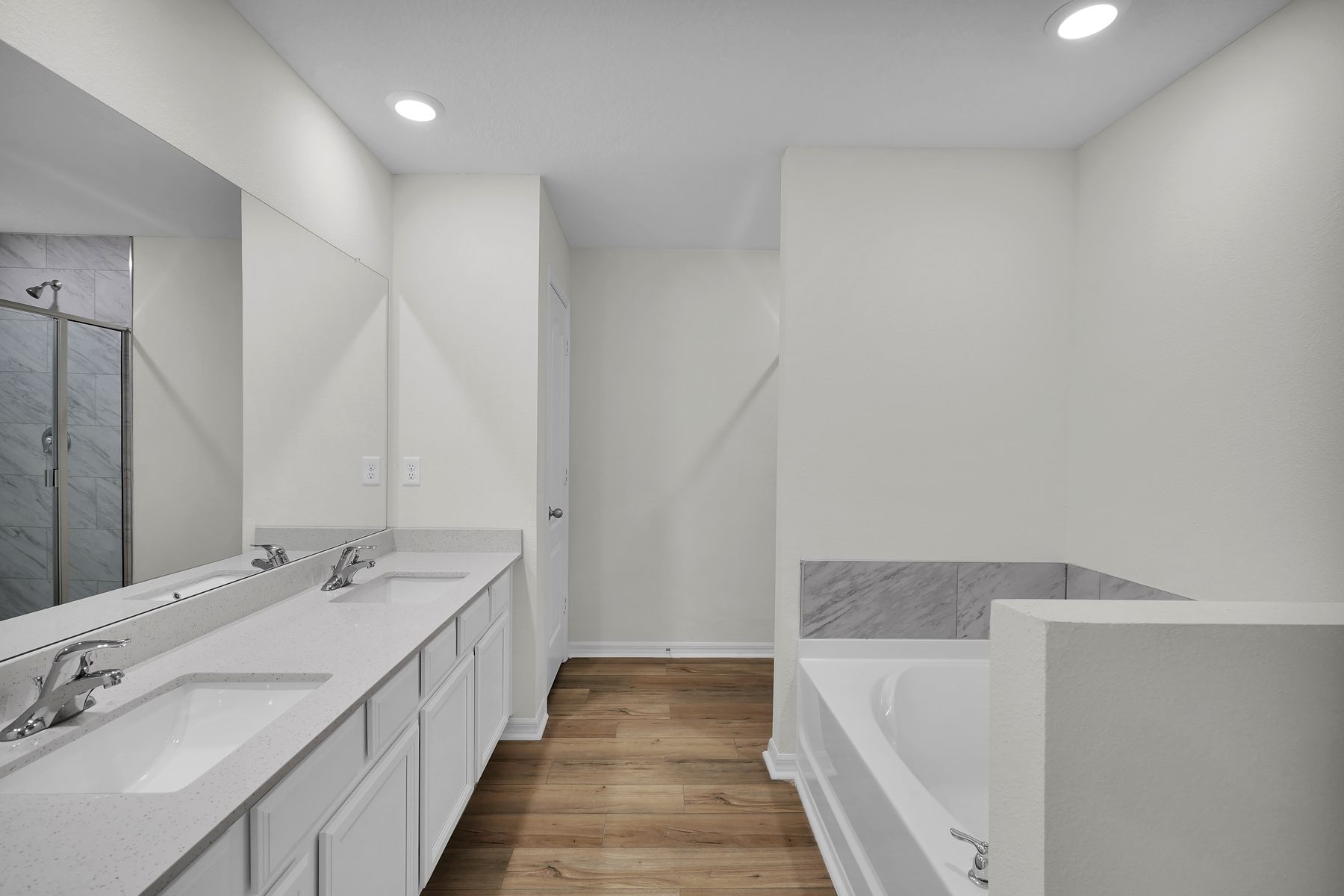 The master bath has a large soaker tub and separate shower.