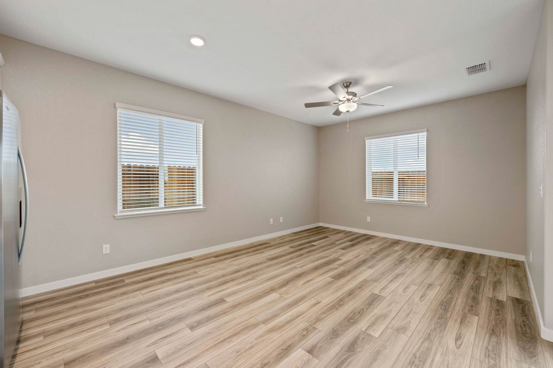The family room is open and has a ceiling fan.