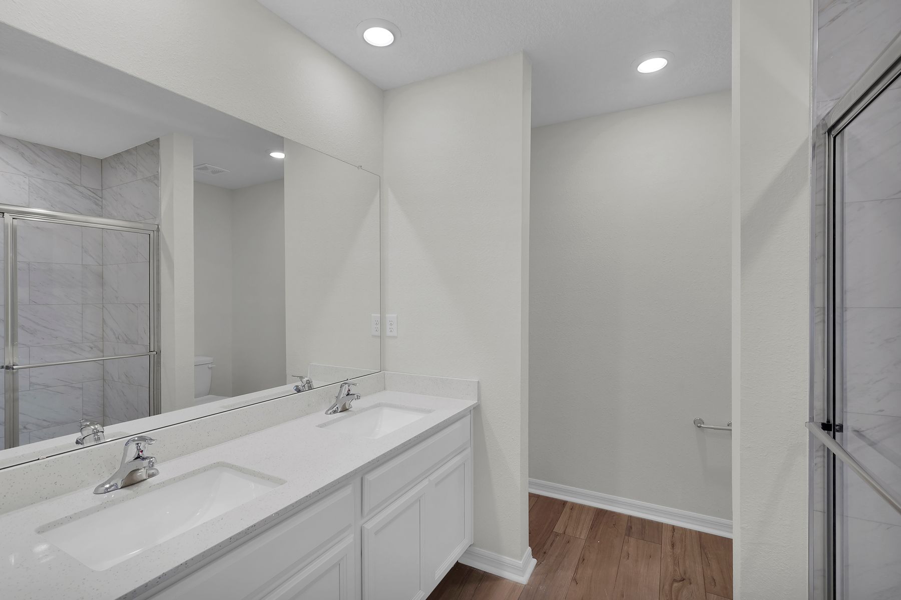 This bathroom features a stunning vanity and a large soaker tub.