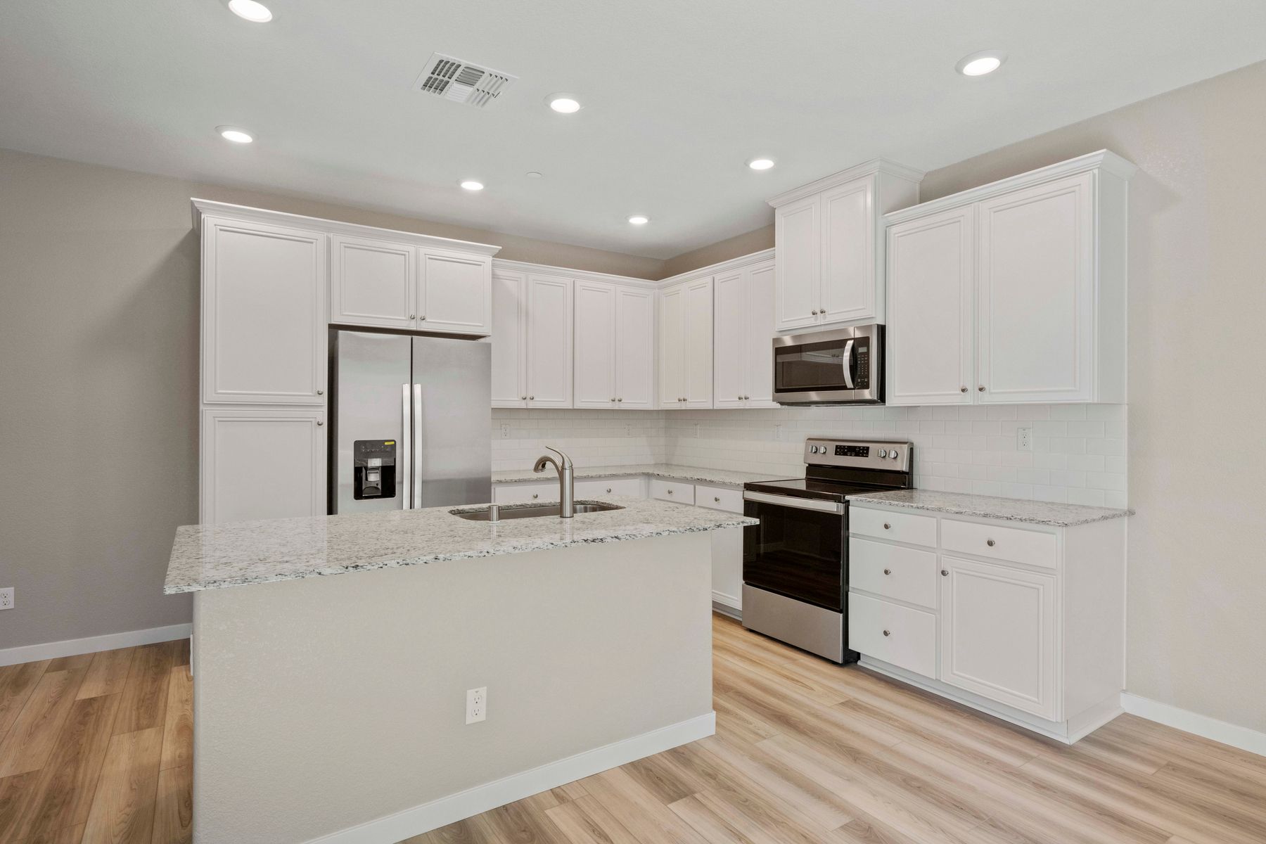 The kitchen in the Shelby has stainless steel appliances and granite countertops.