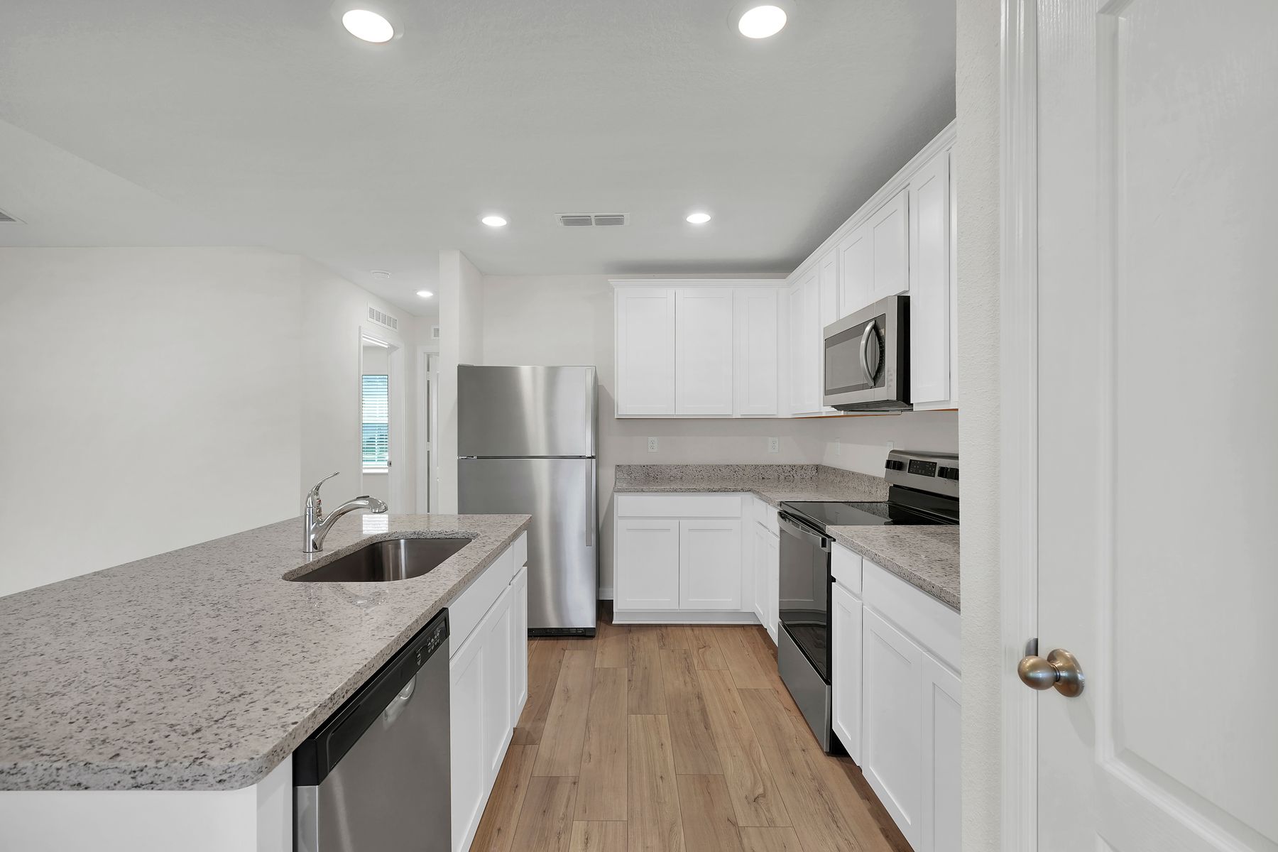 Enjoy stunning granite countertops and designer cabinetry in this kitchen.