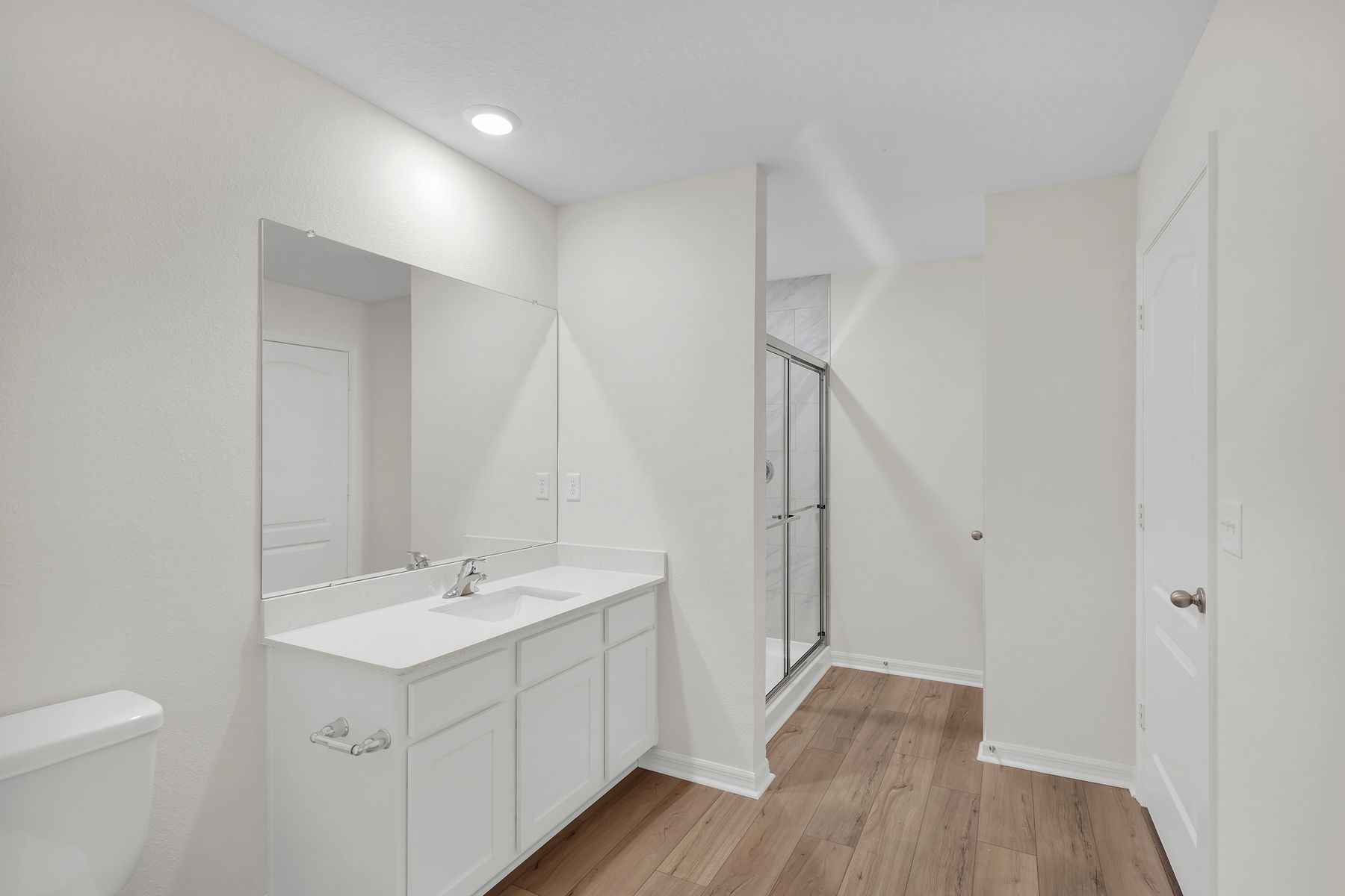 This bathroom has a glass-enclosed shower.
