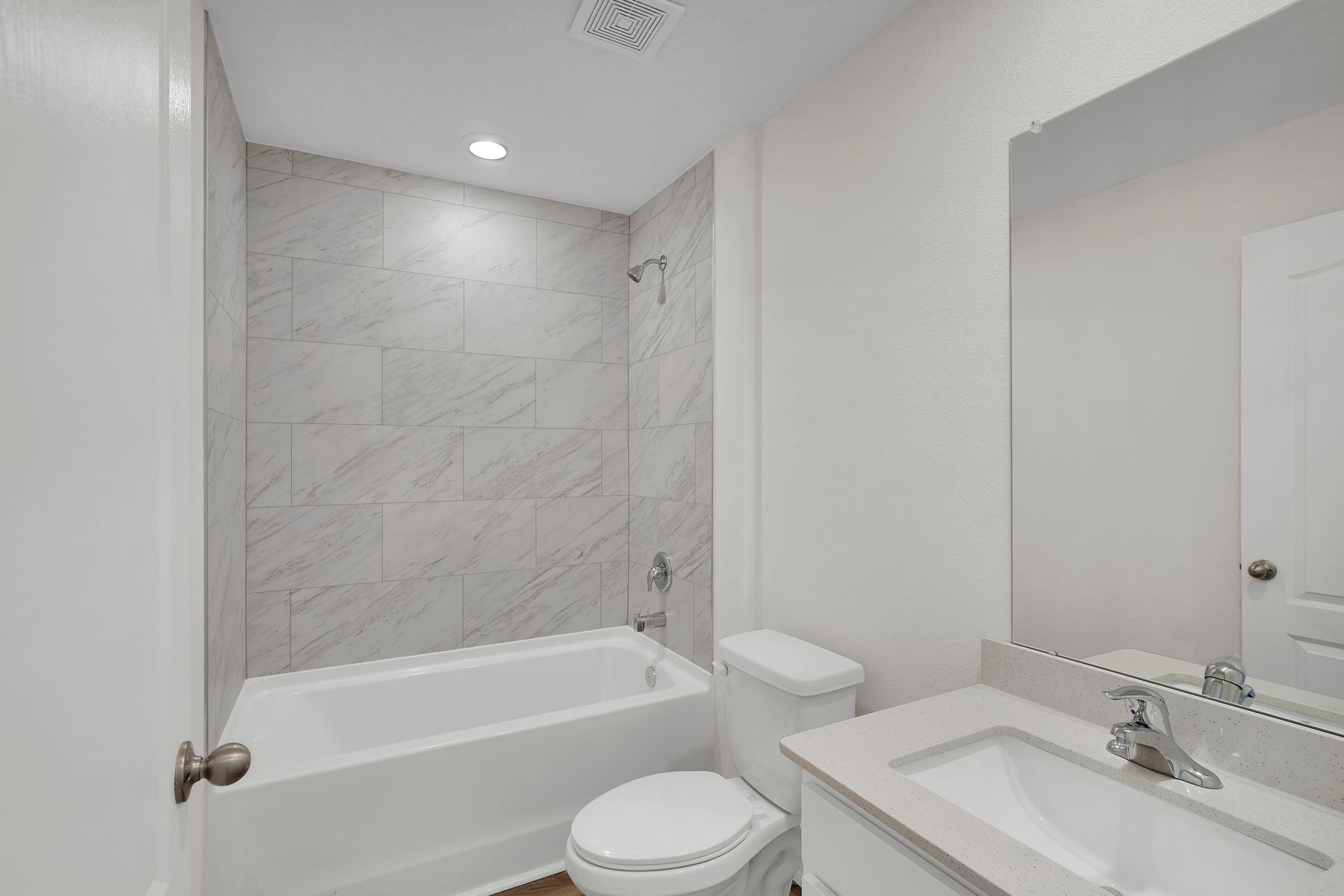 The secondary bathroom has a stunning vanity with a large soaker tub.