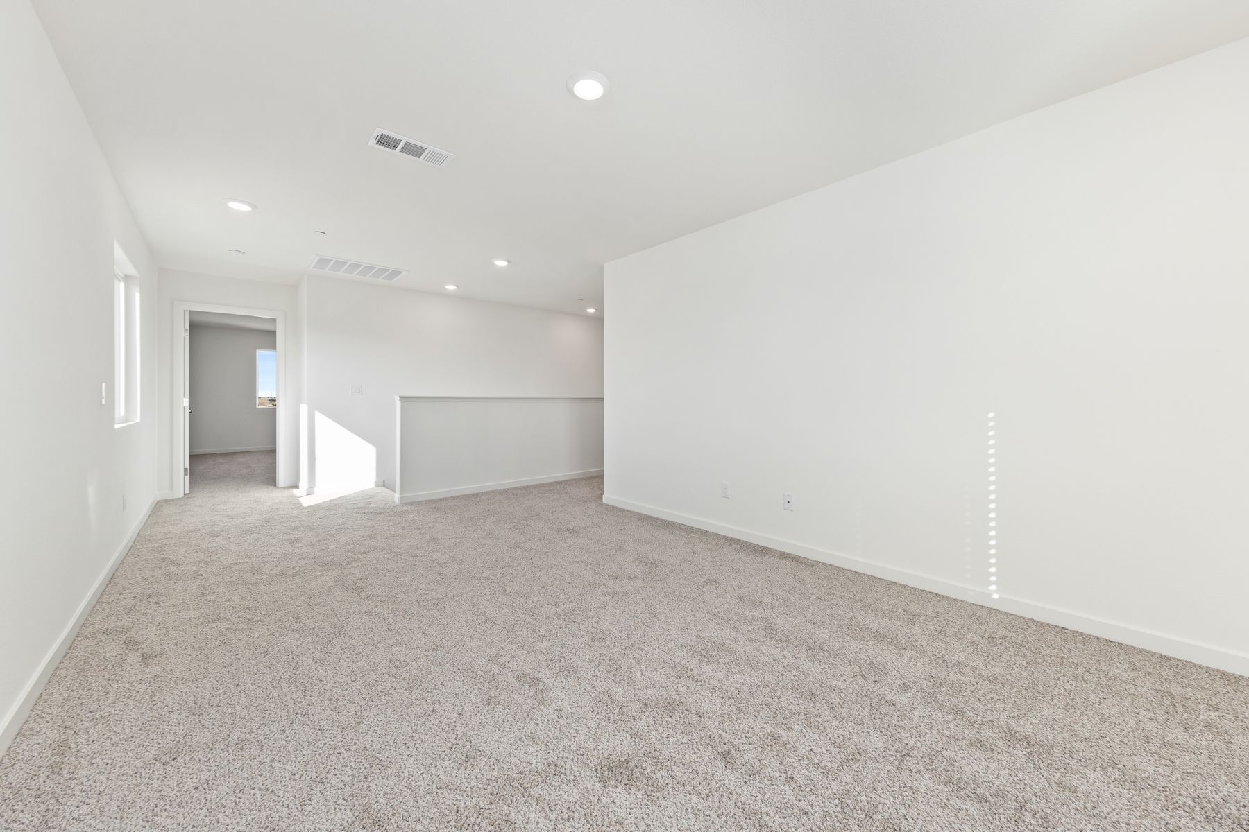 Upstairs there is a game room with carpet.