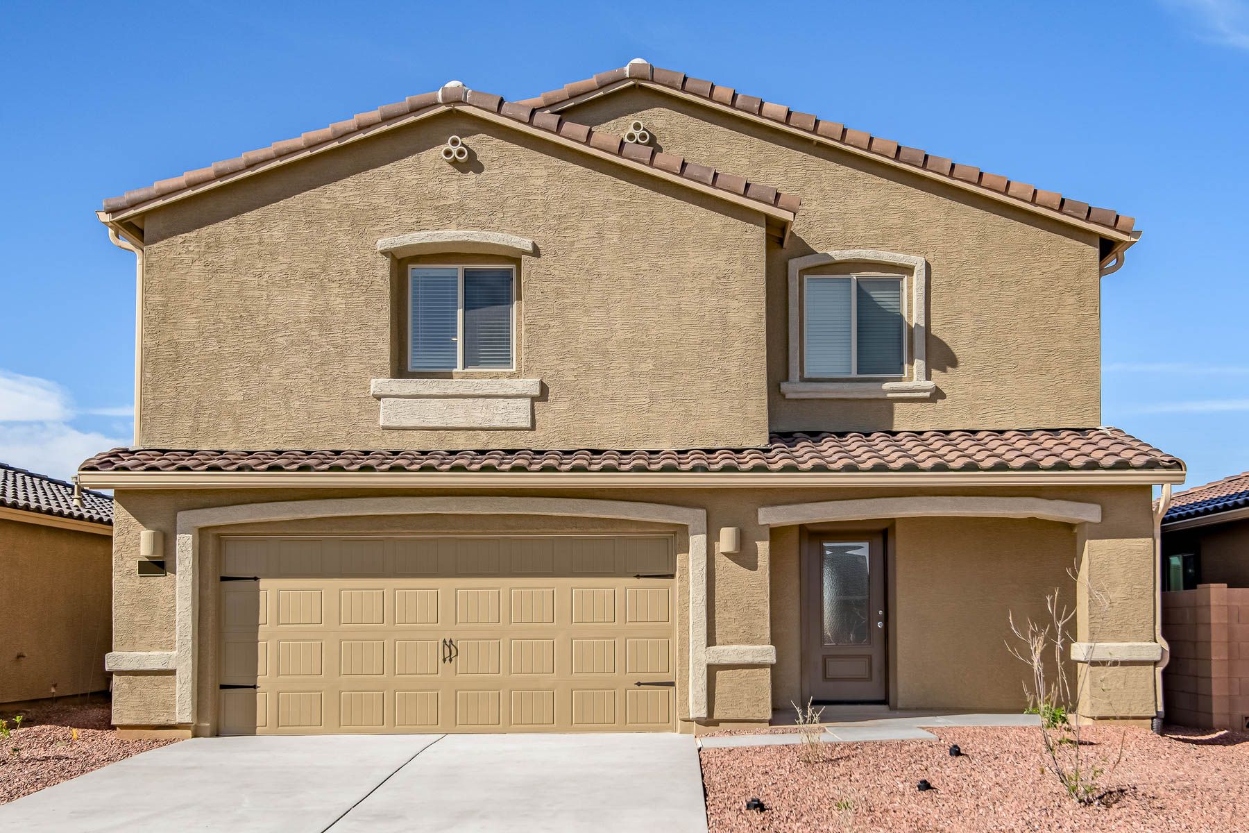 The Stafford by LGI Homes has a stucco exterior and a two-car garage.