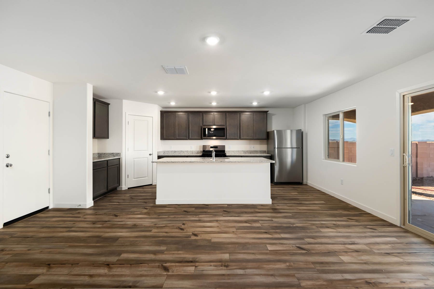 The kitchen has granite countertops and dessigner wood cabinetry