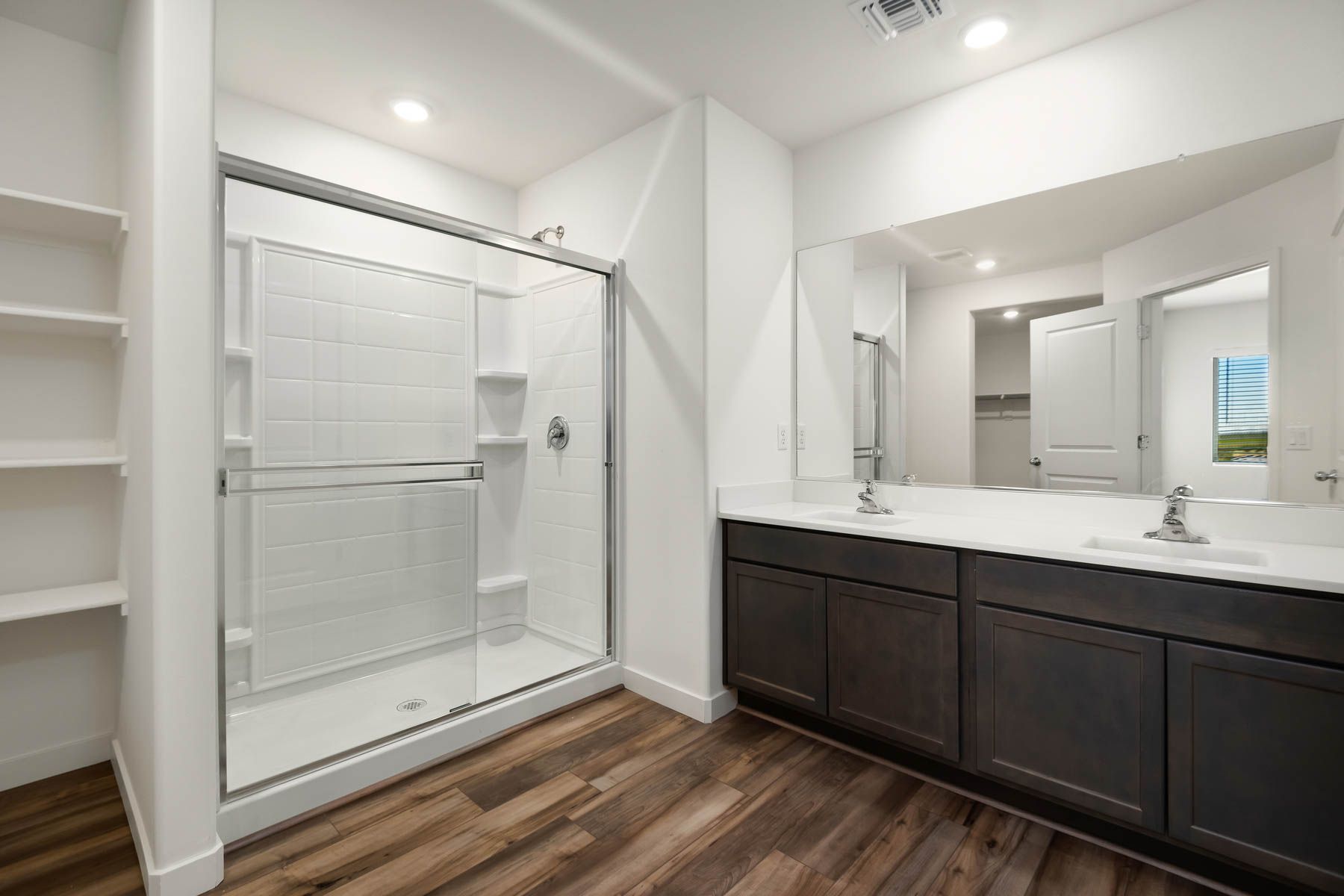 This bathroom has a glass-ecnlosed shower.