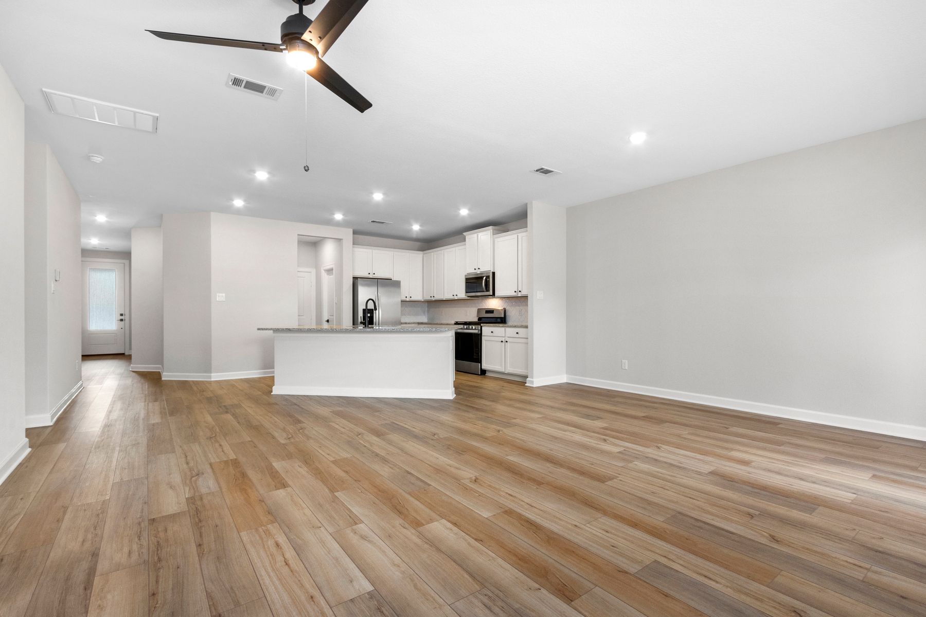 This open floorplan features a connected front room and kitchen!