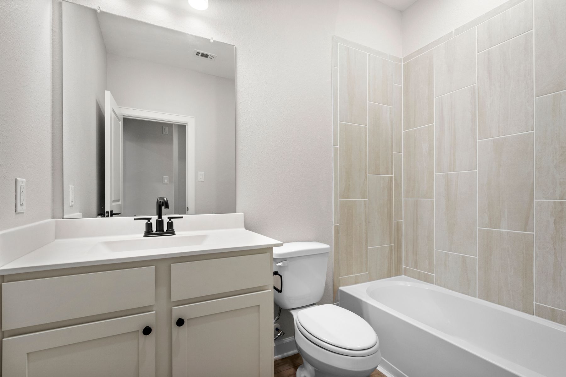 The guest bathroom comes equipped with necessities like a shower bath and full sink!