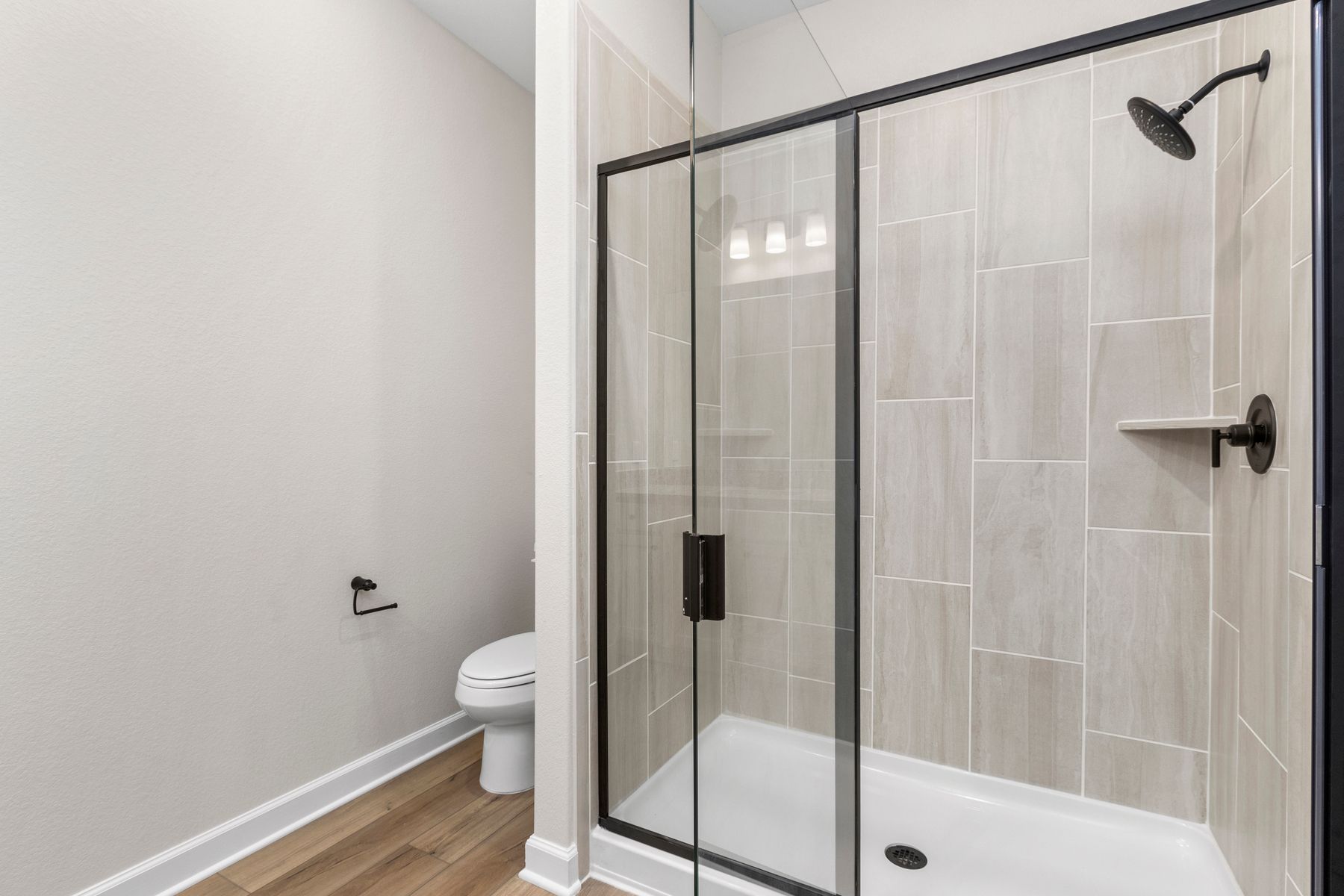 The master bath has a spacious, glass-enclosed shower.