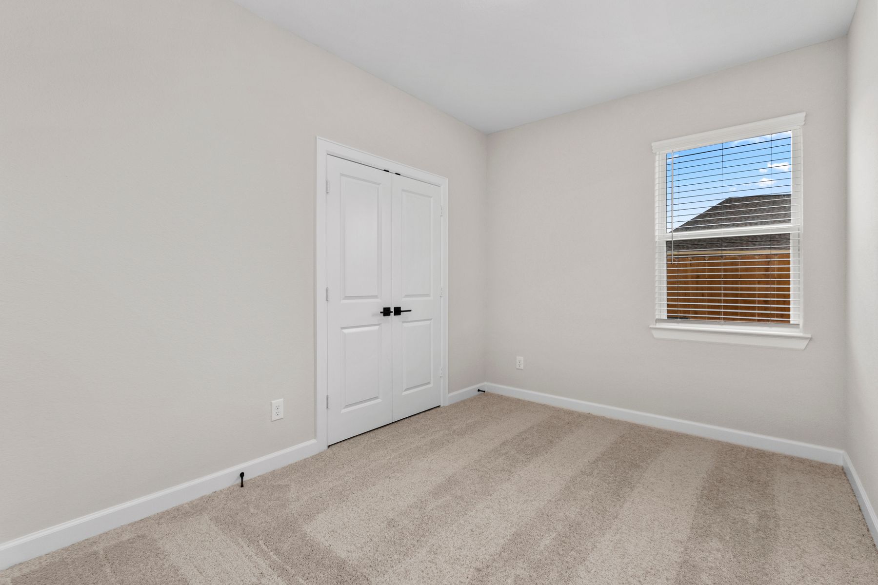 Windows let in plenty of light to this secondary bedroom.