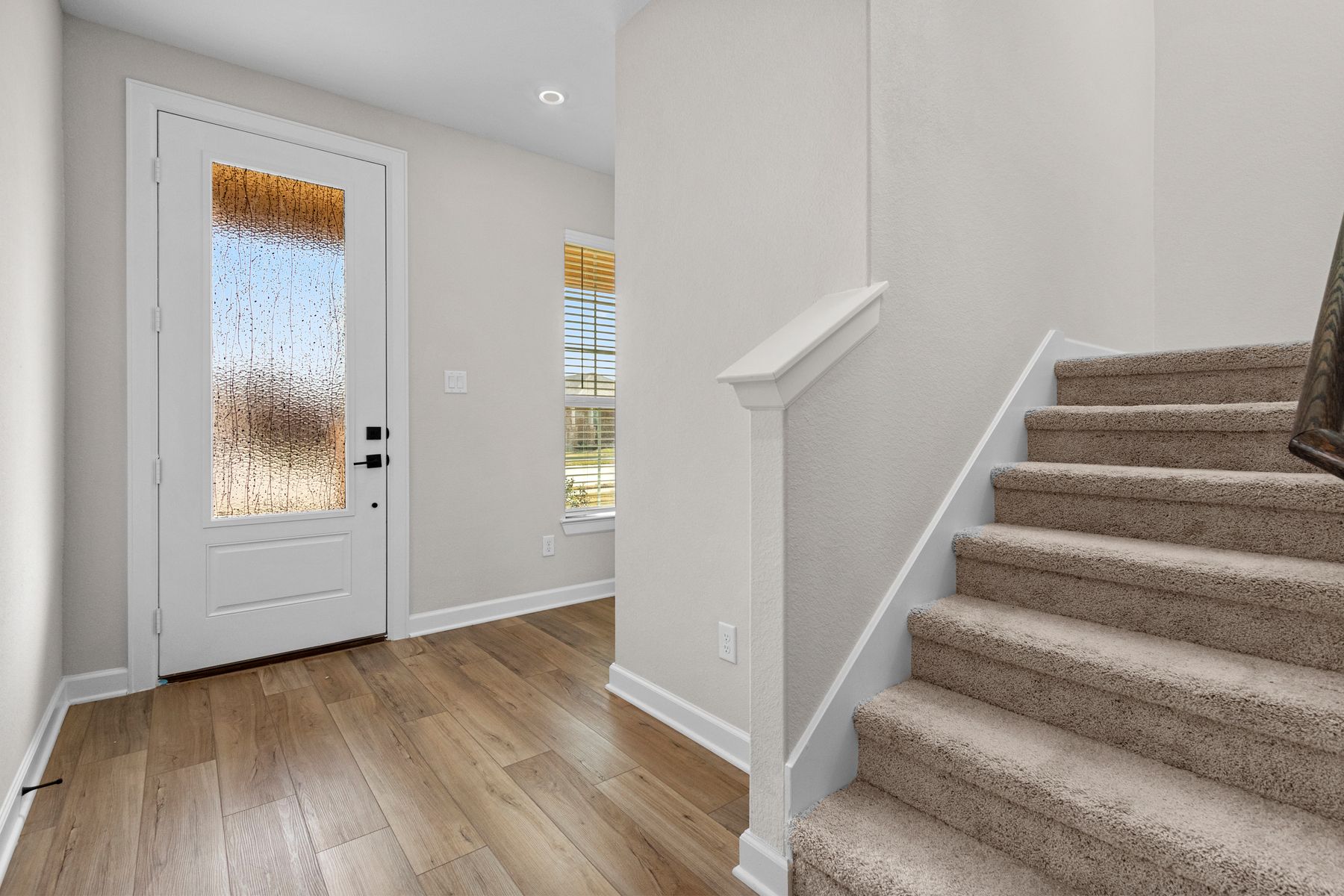 The entryway is highlighted by this gorgeous 3/4 lite door!