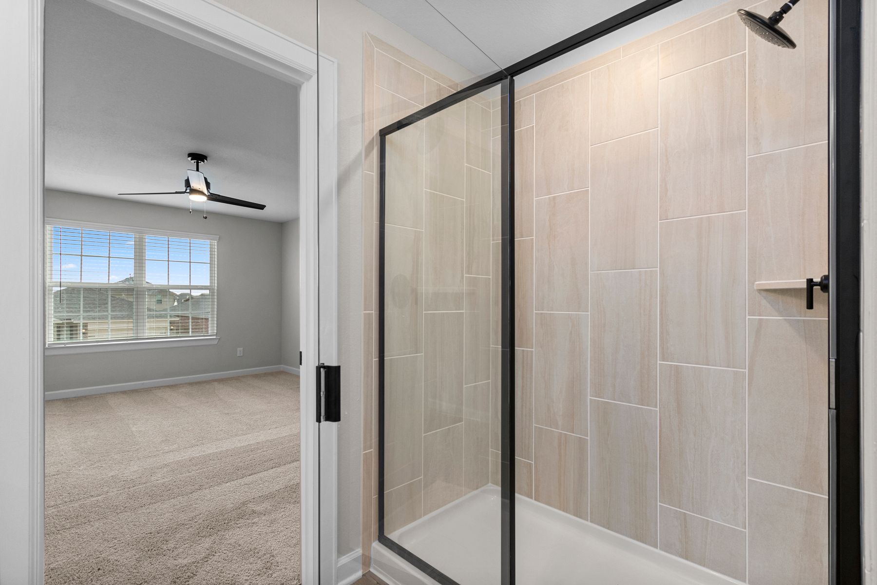 The master bath has a spacious, glass-enclosed shower.