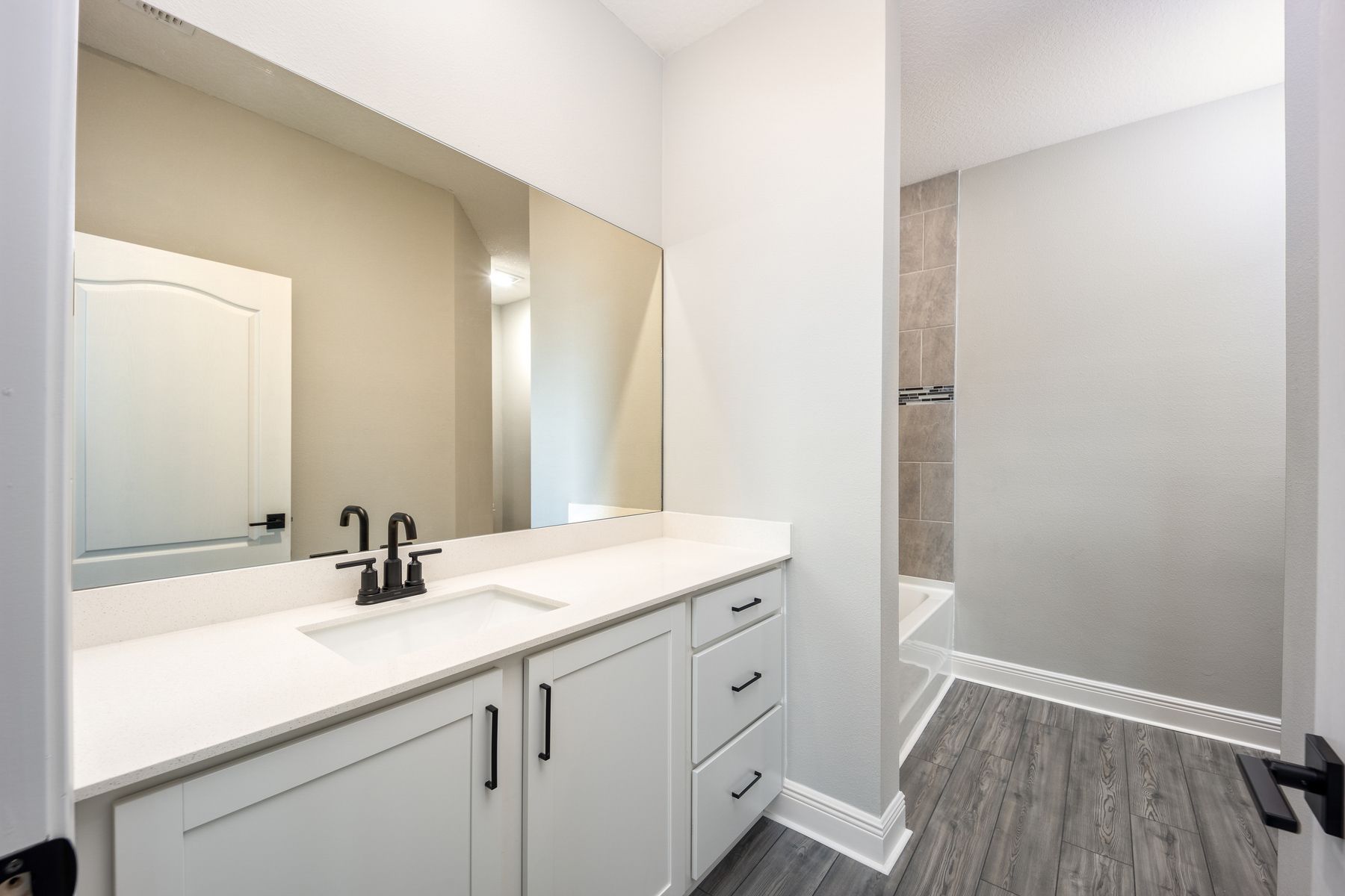 View this master bathroom boasting a stunning vanity.