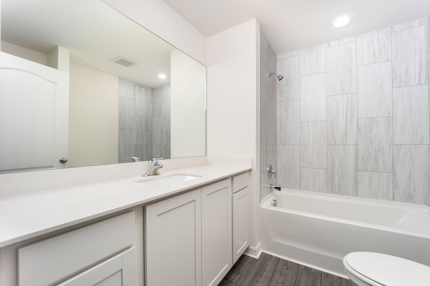 Relax in the master bathroom with the luxerious shower tub with beautifully tiled walls.
