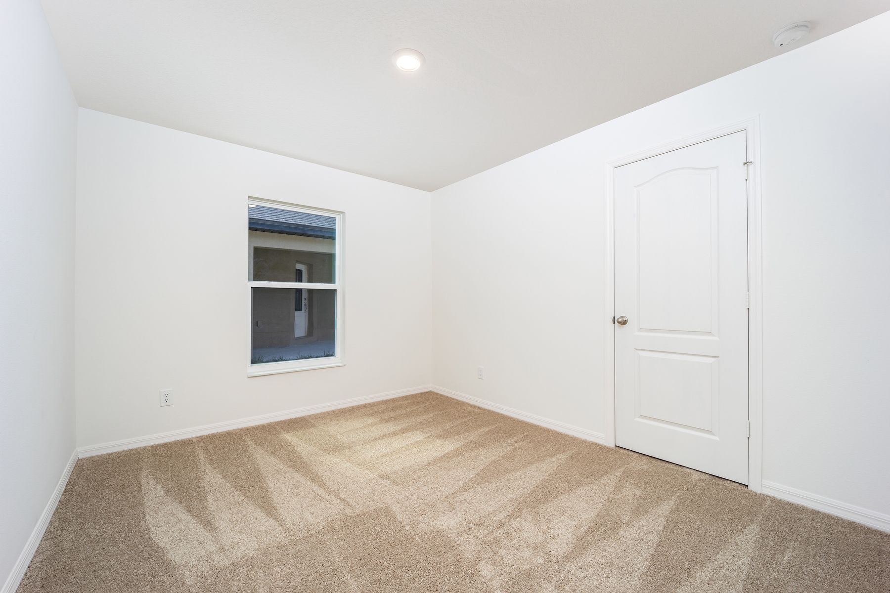 The spacious secondary bedroom of the Ibis plan.