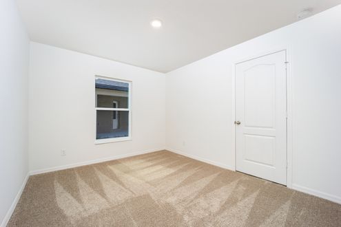 The spacious secondary bedroom of the Ibis plan.