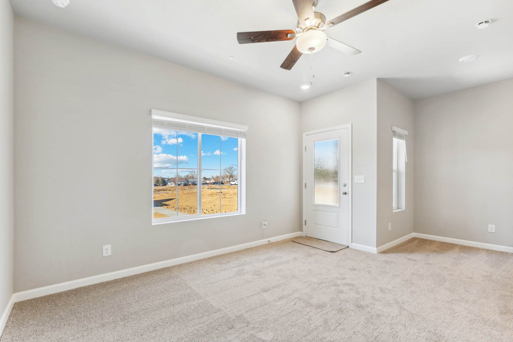 The family room is spacious with a ceiling fan.
